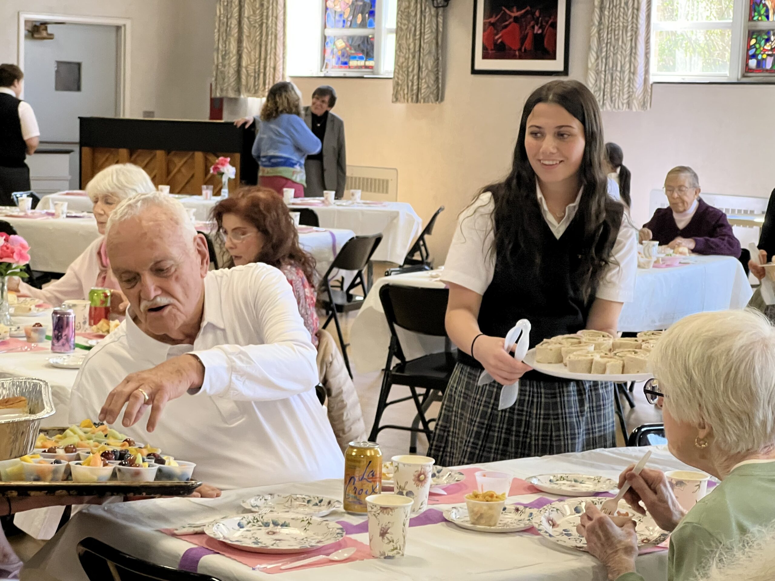 Prep 8 students at Our Lady of the Hamptons School prepared and served a lunch recently to senior citizens at the school.  COURTESY OUR LADY OF THE HAMPTONS