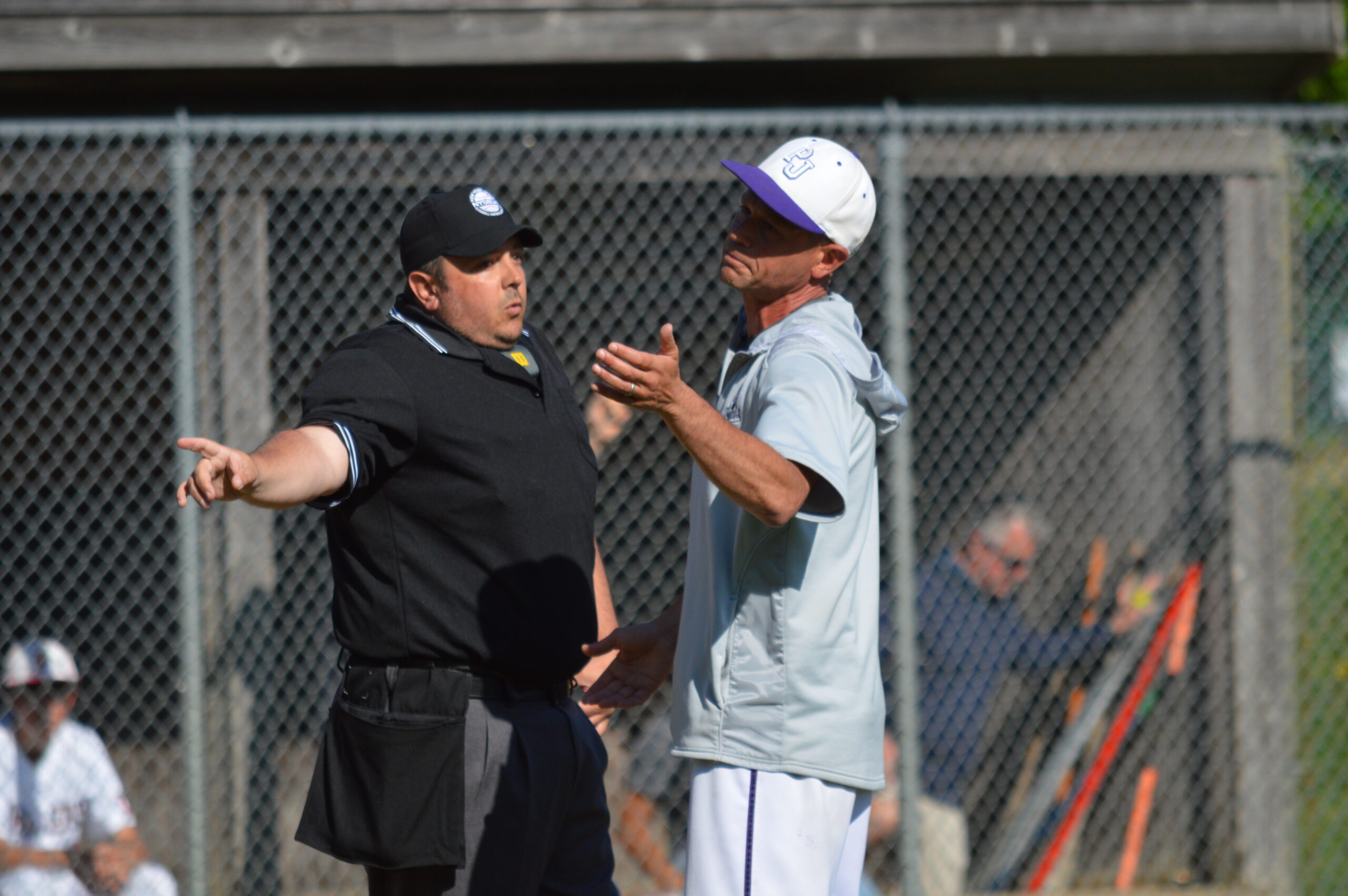 Port Jefferson head coach Jesse Rosen talking to the home plate umpire, who was kept very busy in Tuesday’s playoff game in Sag Harbor.