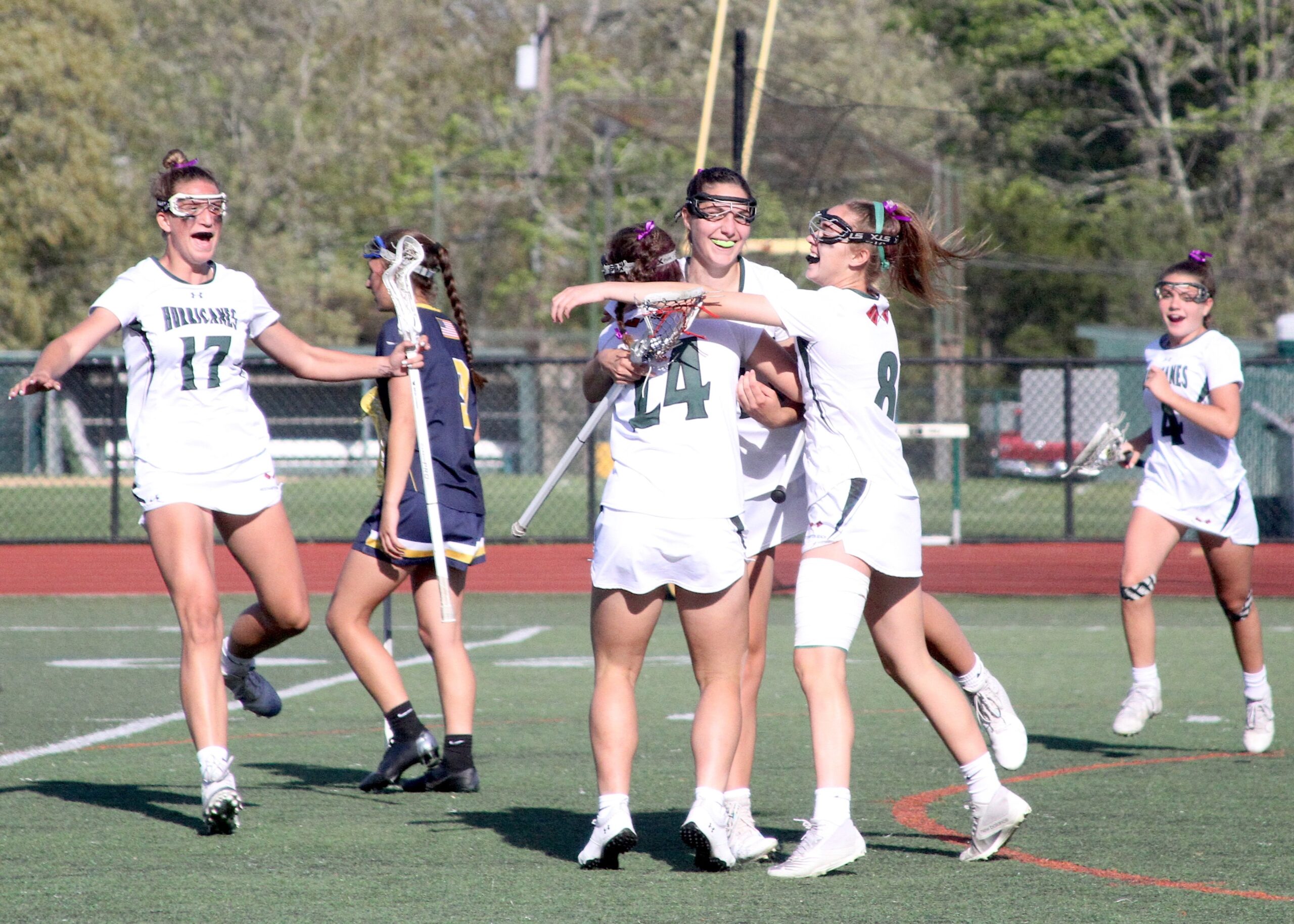 Junior midfielder and defender Reilly Mahon is surrounded by teammates following her second score. DESIRÉE KEEGAN