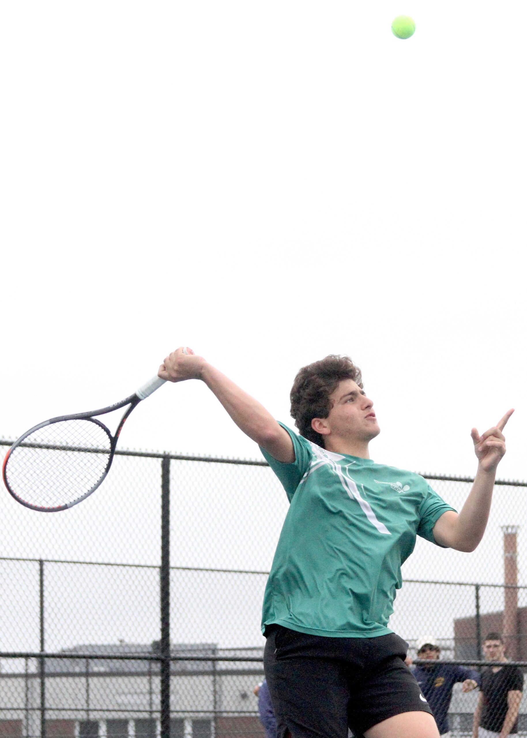 Westhampton Beach senior Sandro Volpe slams down a point with a volley from the net. DESIRÉE KEEGAN