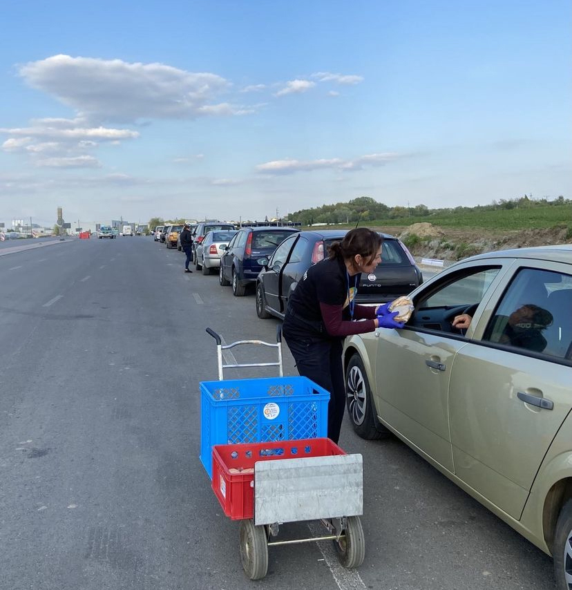 Luisa Kane brings food to someone waiting to cross the border. The line stretched as far as 8 kilometers.