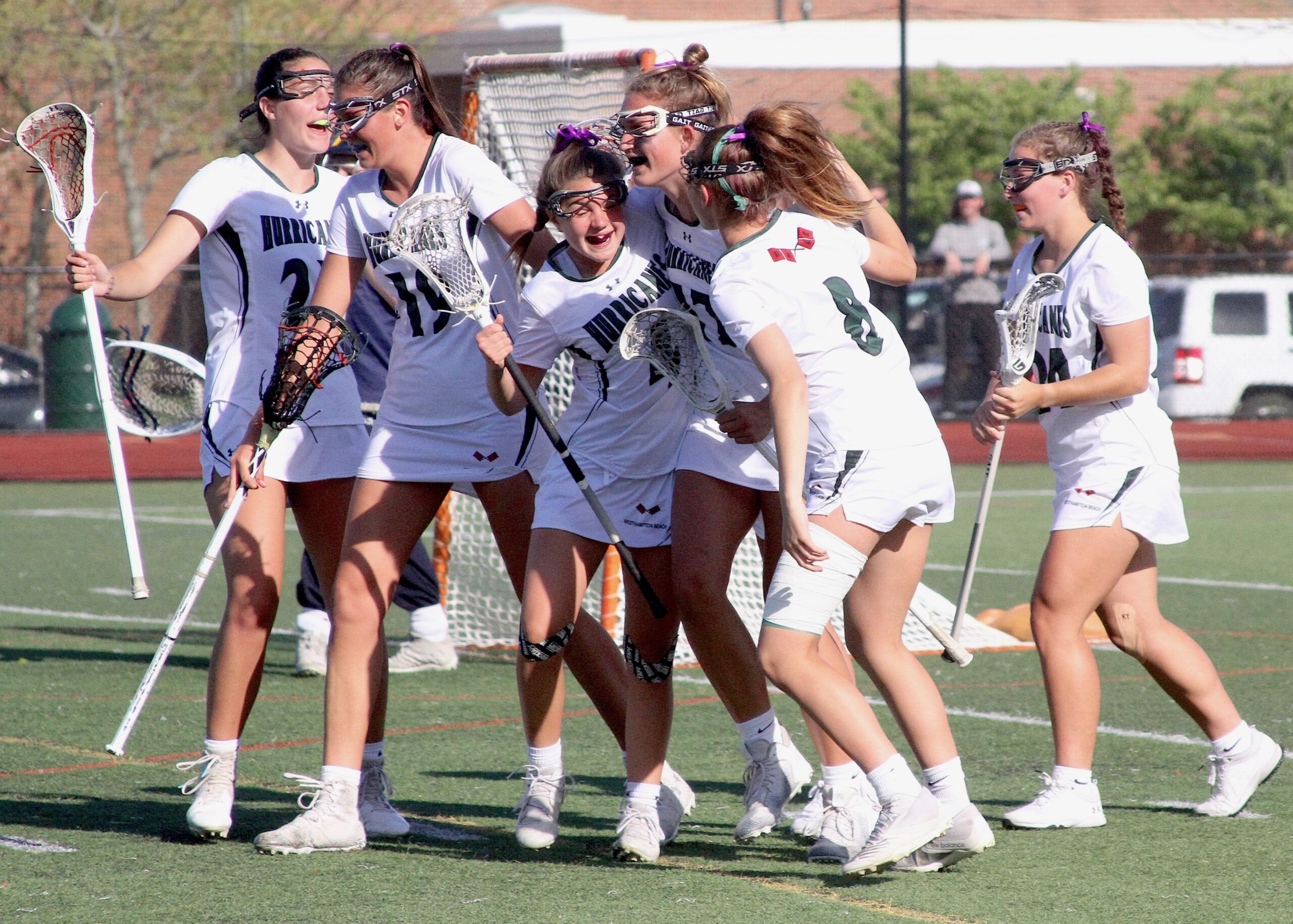 Westhampton Beach's offense surrounds Olivia Rongo and Reese King following their game-winning goal. DESIRÉE KEEGAN