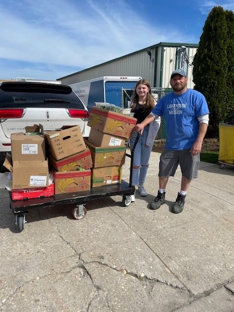 Westhampton Beach High School student Madison Esposito has been volunteering her time collecting food for Lighthouse Mission in Bellport. Madison with Gabriel Faraci, a volunteer worker for Lighthouse Mission. COURTESY WESTHAMPTON BEACH SCHOOL DISTRICT