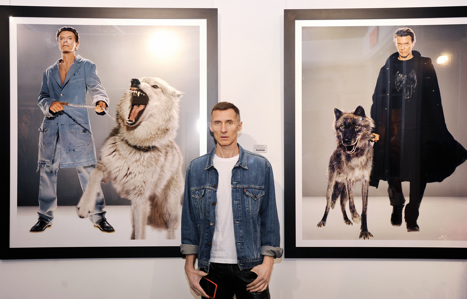 Photographer Makus Klinko with his photographs in the 2019 London exhibition 