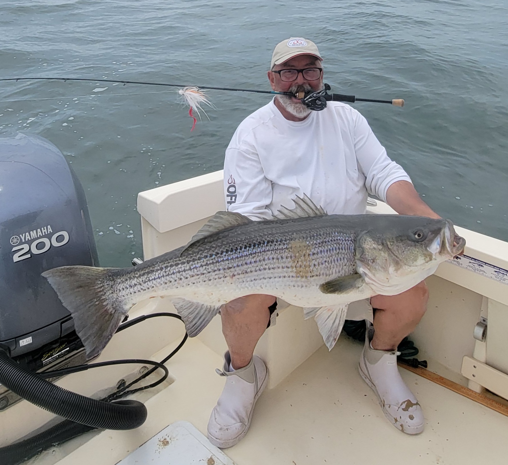 Capt. Savio Mizzi of Fish Hooker Charters with a monster Montauk striped bass caught over the weekend on light tackle.