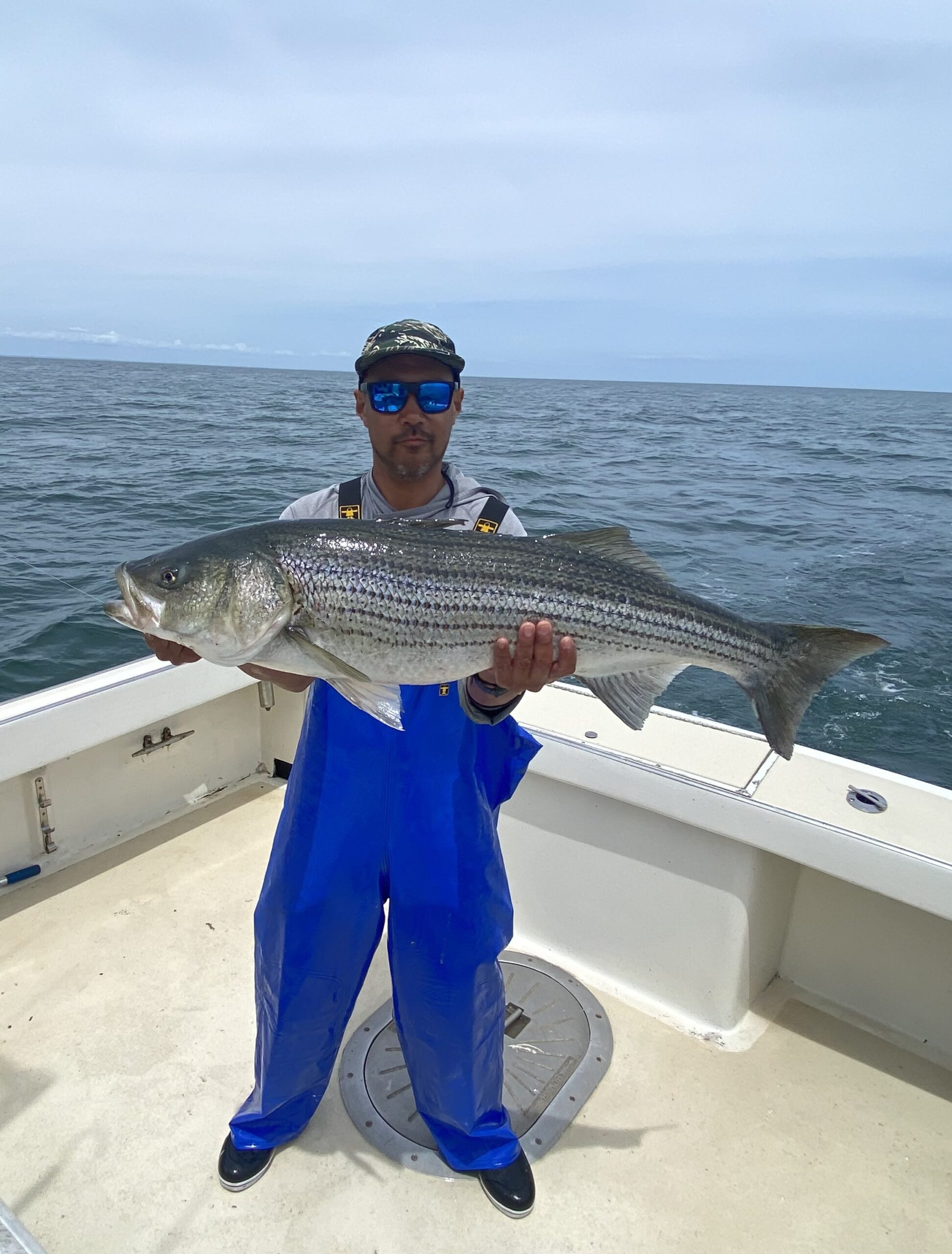 Eiji Shiga shows off a trophy Montauk striped bass before release.