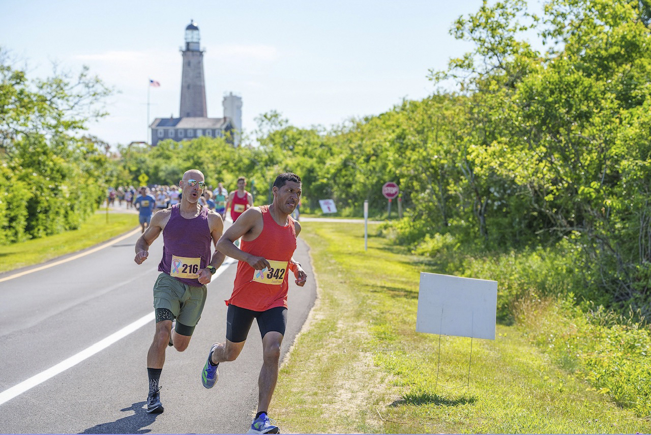 Claudio Telles and Justin Kulchinsky, the top two finishers at the Beacon of Hope 5K in Montauk on Saturday, round the corner and head toward Camp Hero.      LONG ISLAND RUNNING