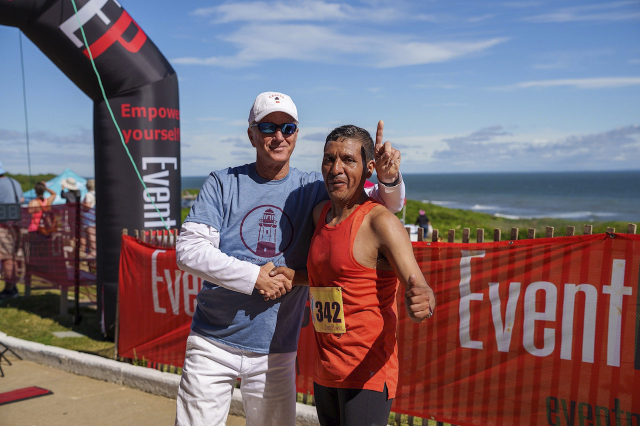 Joe Gaviola, left, the keeper of the Montauk Point Lighthouse, with the overall winner of Saturday’s Beacon of Hope 5K, Claudio Telles. 
LONG ISLAND RUNNING