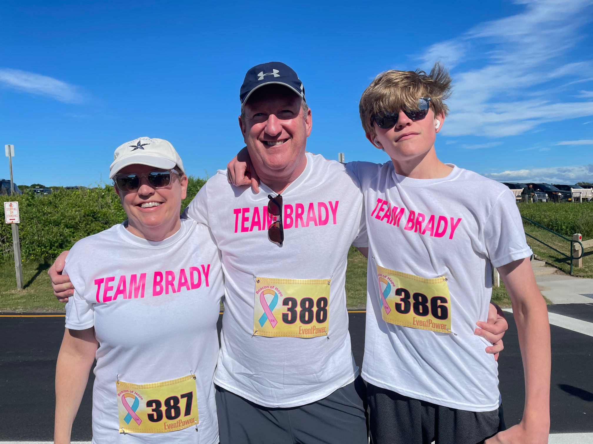 Dr. James Brady, center, with his wife, Lisa, and son, Ronan, before the start of the Beacon for Hope 5K on Saturday.       GAVIN MENU