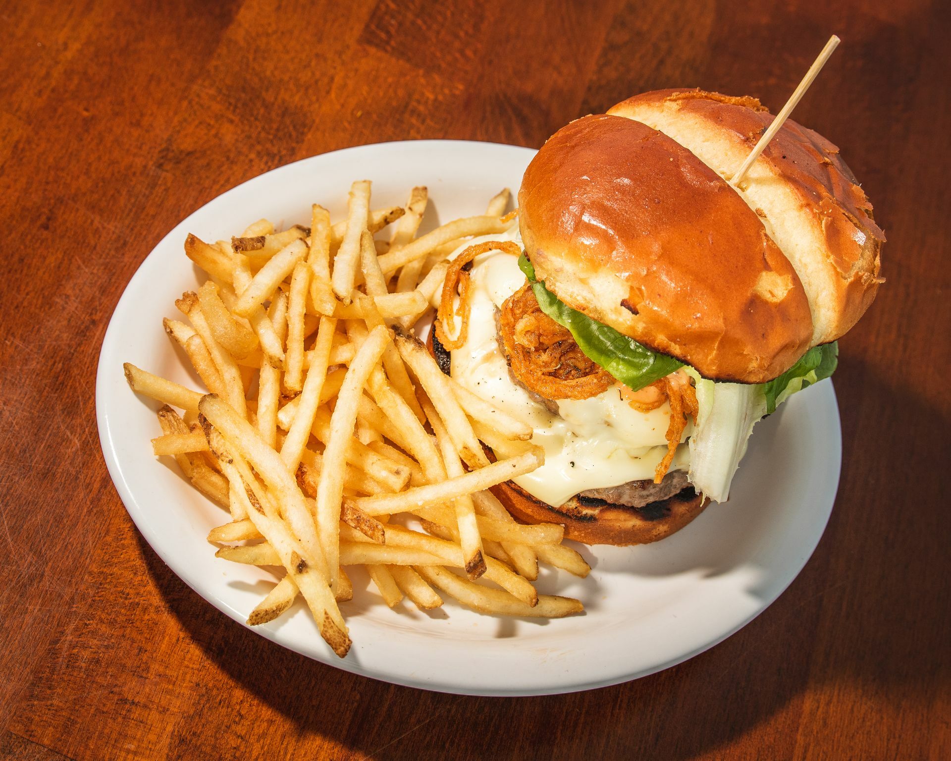 Burger and fries are available on the happy hour menu at Manna at Lobster Inn. ROBIN LEE