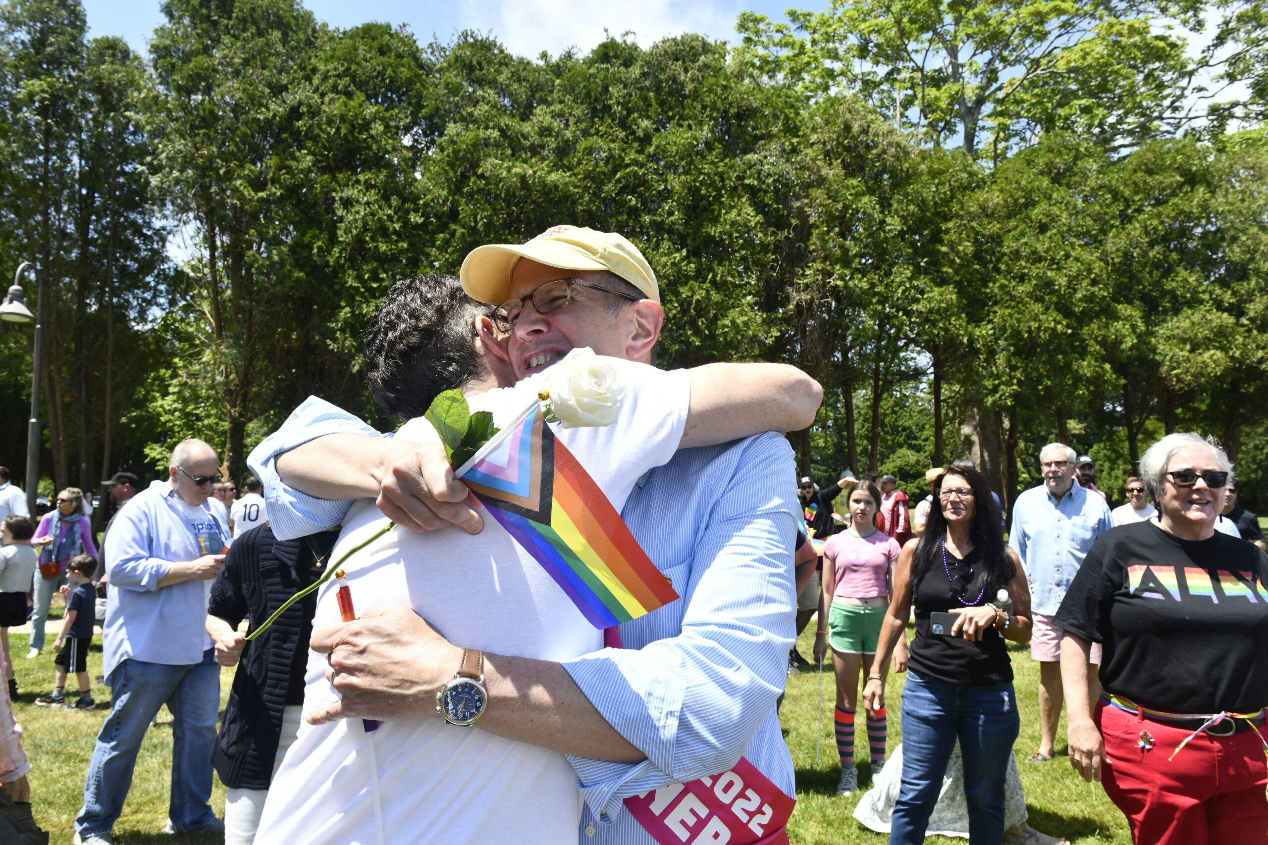 Tom House, President of Hamptons Pride Hugs Grand Marshal Robert Chaloner after the parade.