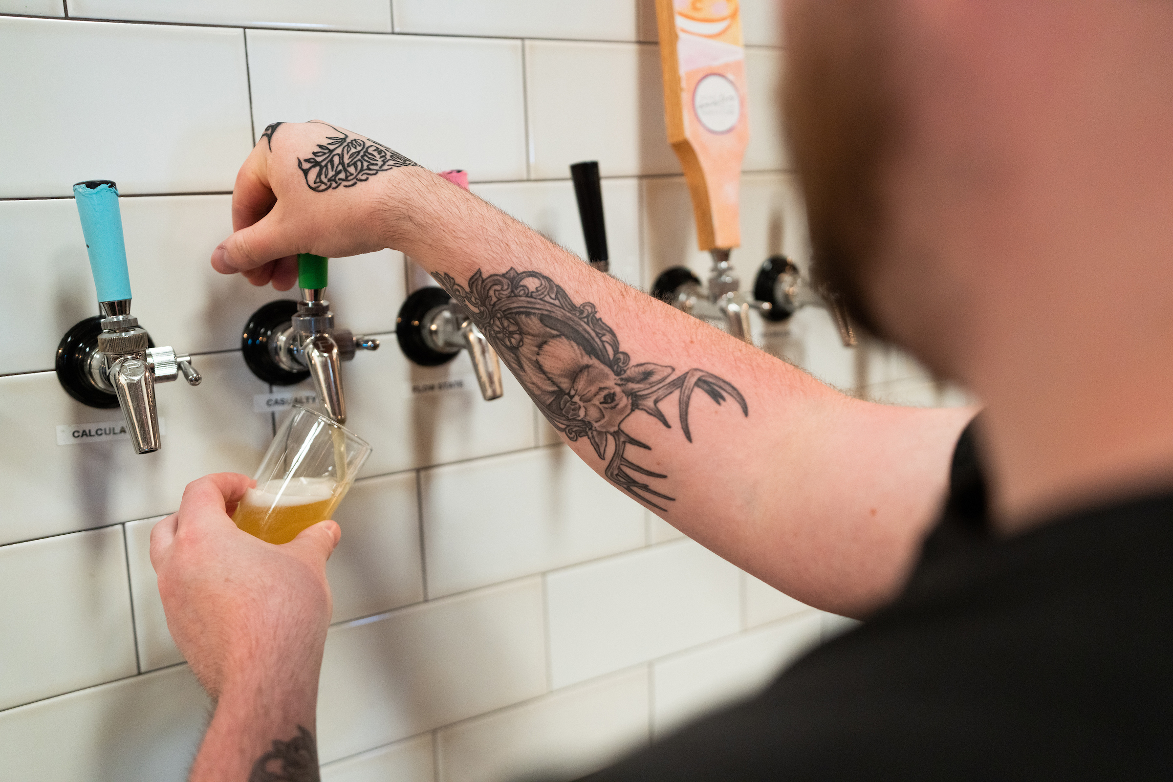 Lenny Van Vliet pouring beer at übergeek in Riverhead, New York. 