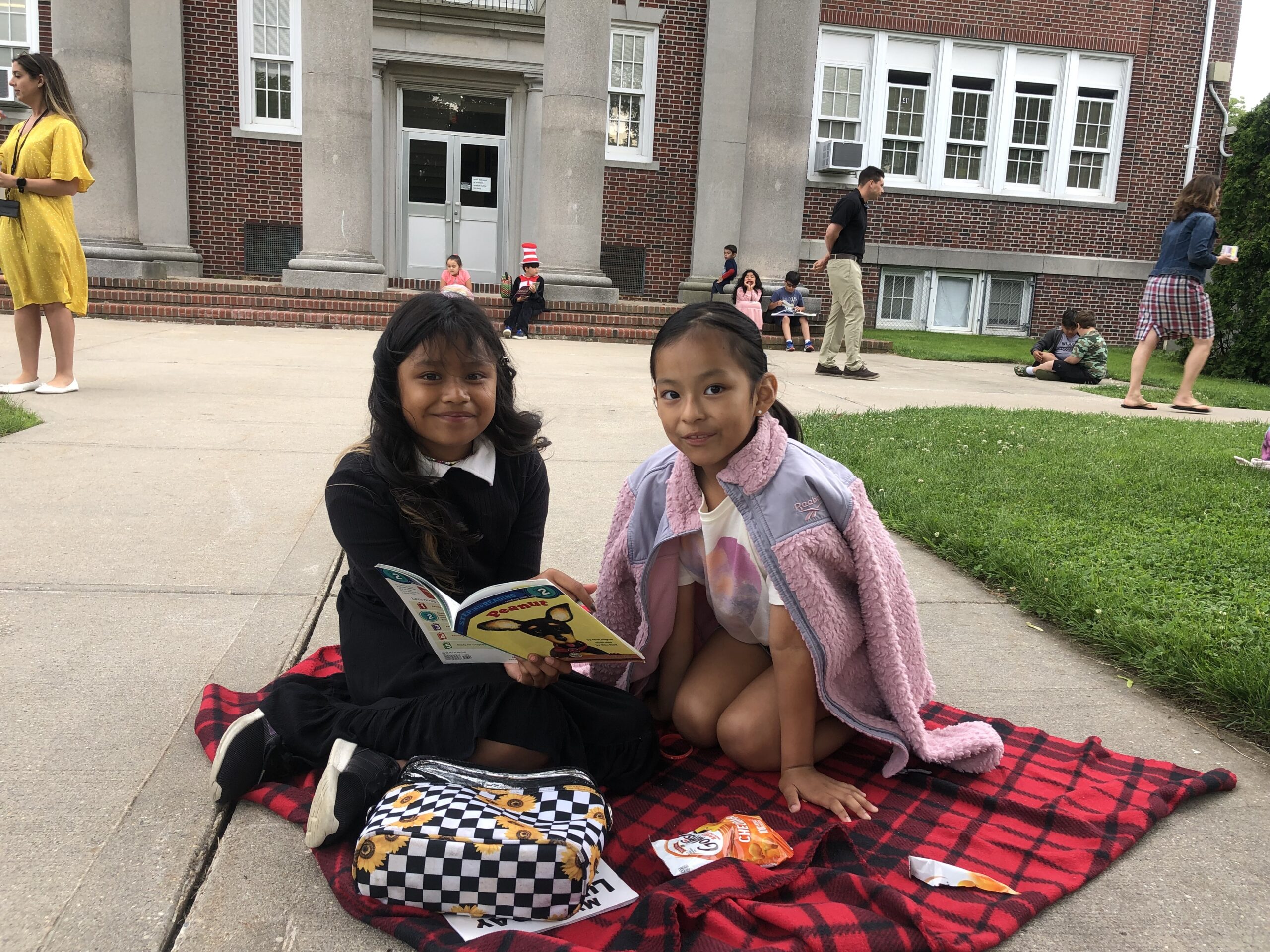 To foster a love of reading in fellow students, Amy McNamara’s fourth graders at Hampton Bays Elementary School spent a sunny afternoon reading to their first grade buddies.  Mia Soledad, left, with Daphne Chiliquinga on reading day. COURTESY HAMPTON BAYS SCHOOL DISTRICT