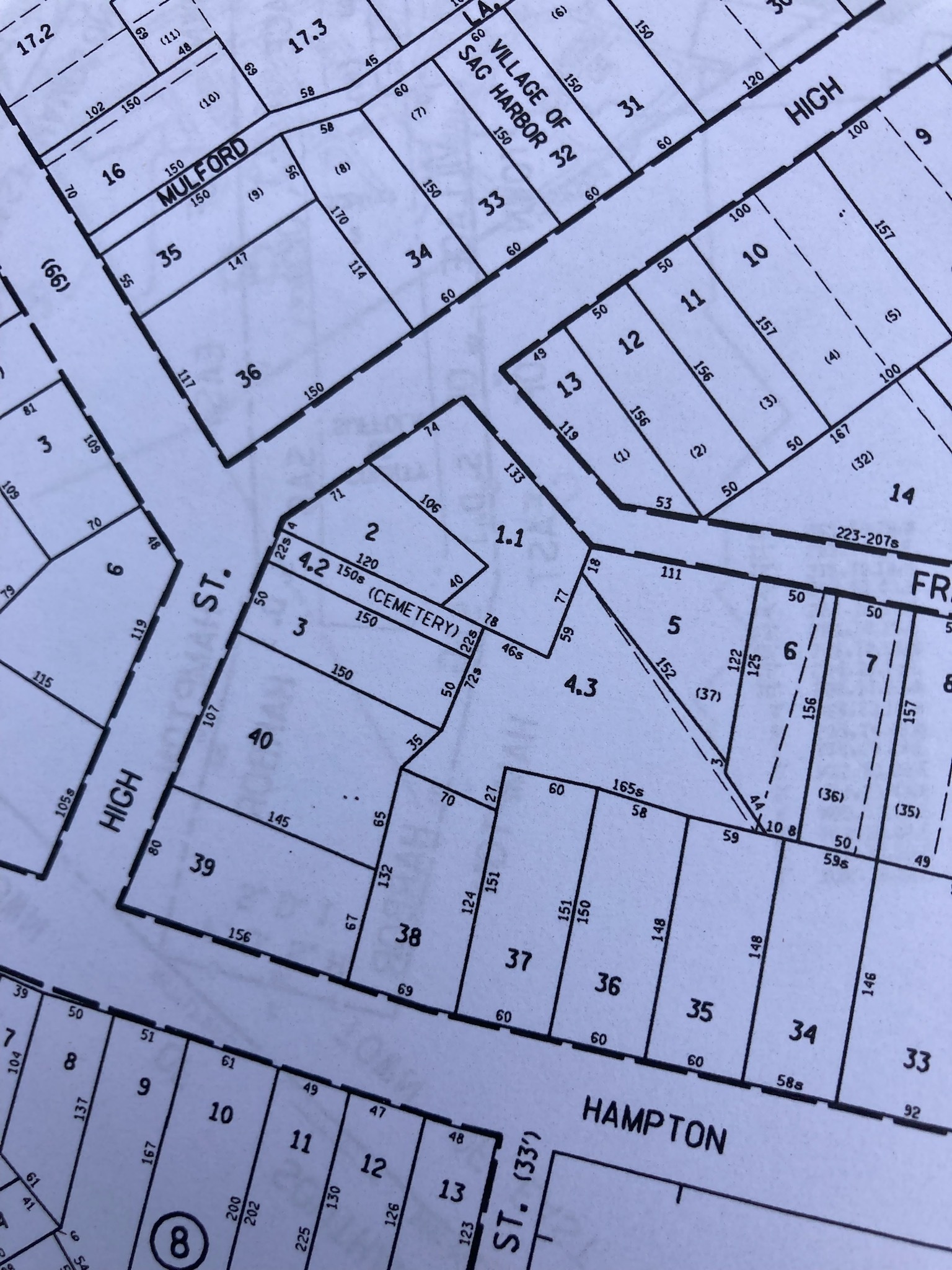 A Suffolk County tax map shows a thin strip labeled as cemetery.