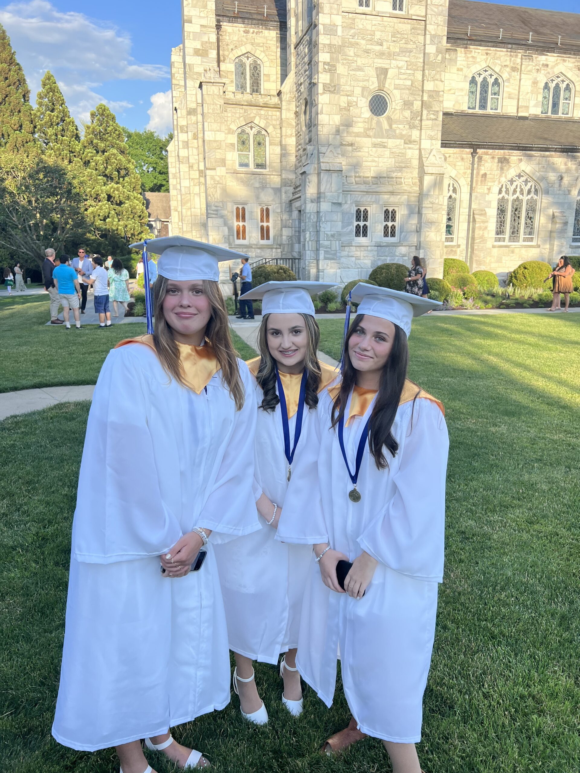 Our Lady of the Hamptons School students, from left,  Ava Phair, Sarah Hoffman and Jenna DiDomenico were among those who received their diplomas during a commencement ceremony at the Basilica Parish of Sacred Hearts of Jesus and Mary recently. COURTESY OUR LADY OF THE HAMPTONS SCHOOL