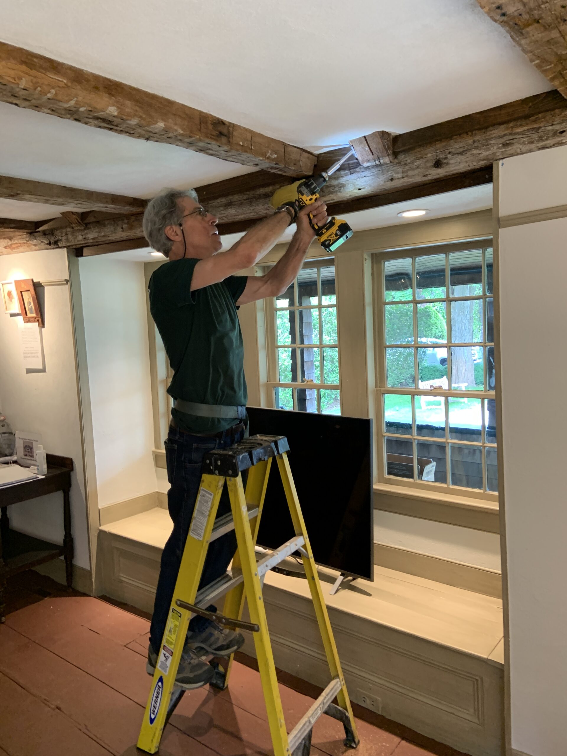 Bill Flynt removes a sample from a wood beam in the Sag Harbor Historical Society's Annie Cooper Boyd House. STEPHEN J. KOTZ