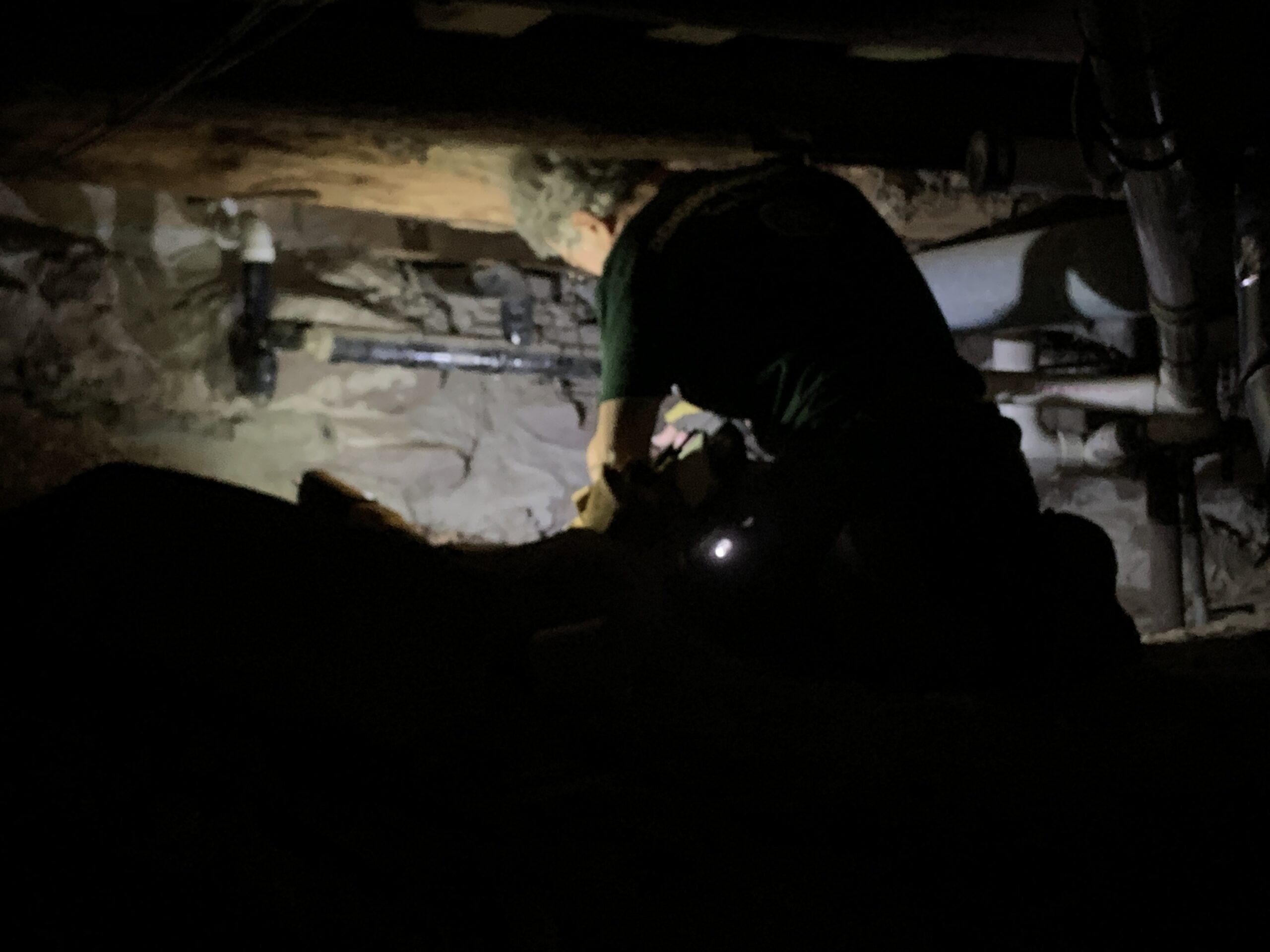 Bill Flynt works in the tight confines of the crawl space of the  Sag Harbor Historical Society's Annie Cooper Boyd House. STEPHEN J. KOTZ