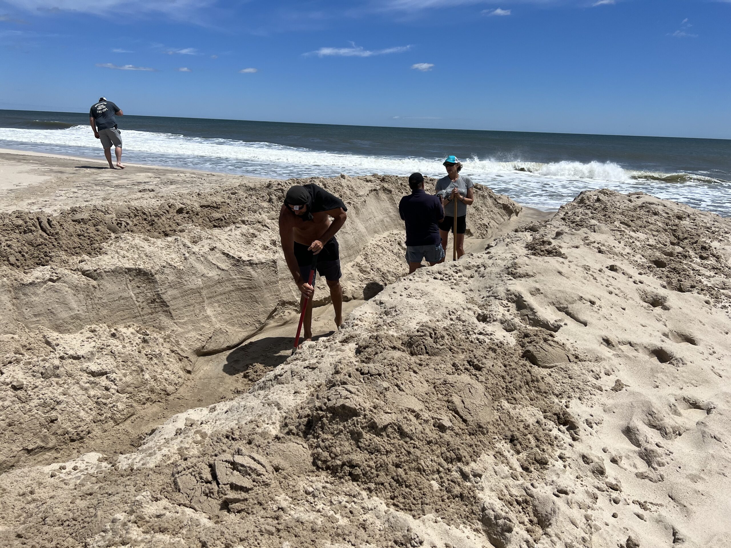 Volunteers opened Mecox Bay to the ocean on Saturday. DANA SHAW