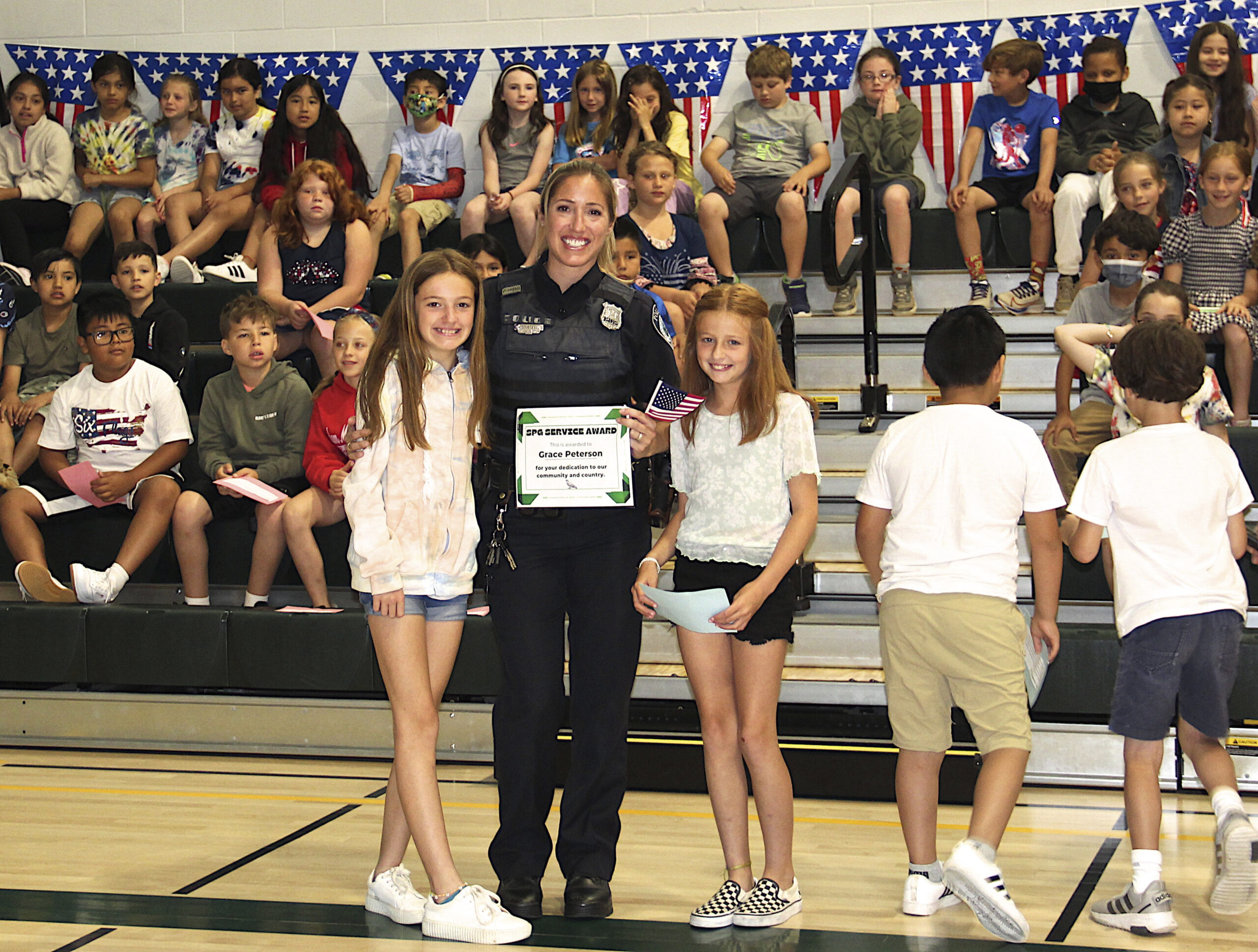 East Hampton Town Police Officer Grace Peterson was honored at the Springs School Flag Day ceremony on Tuesday, June 14.  KYRIL BROMLEY