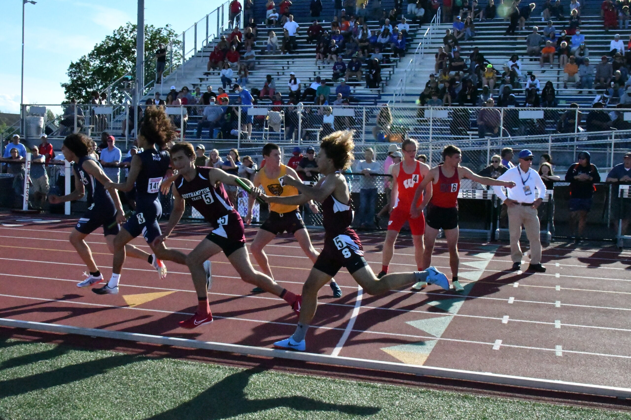 Southampton senior Saintino Arnold hands off to classmate Billy Malone in the 4x400-meter relay at states.