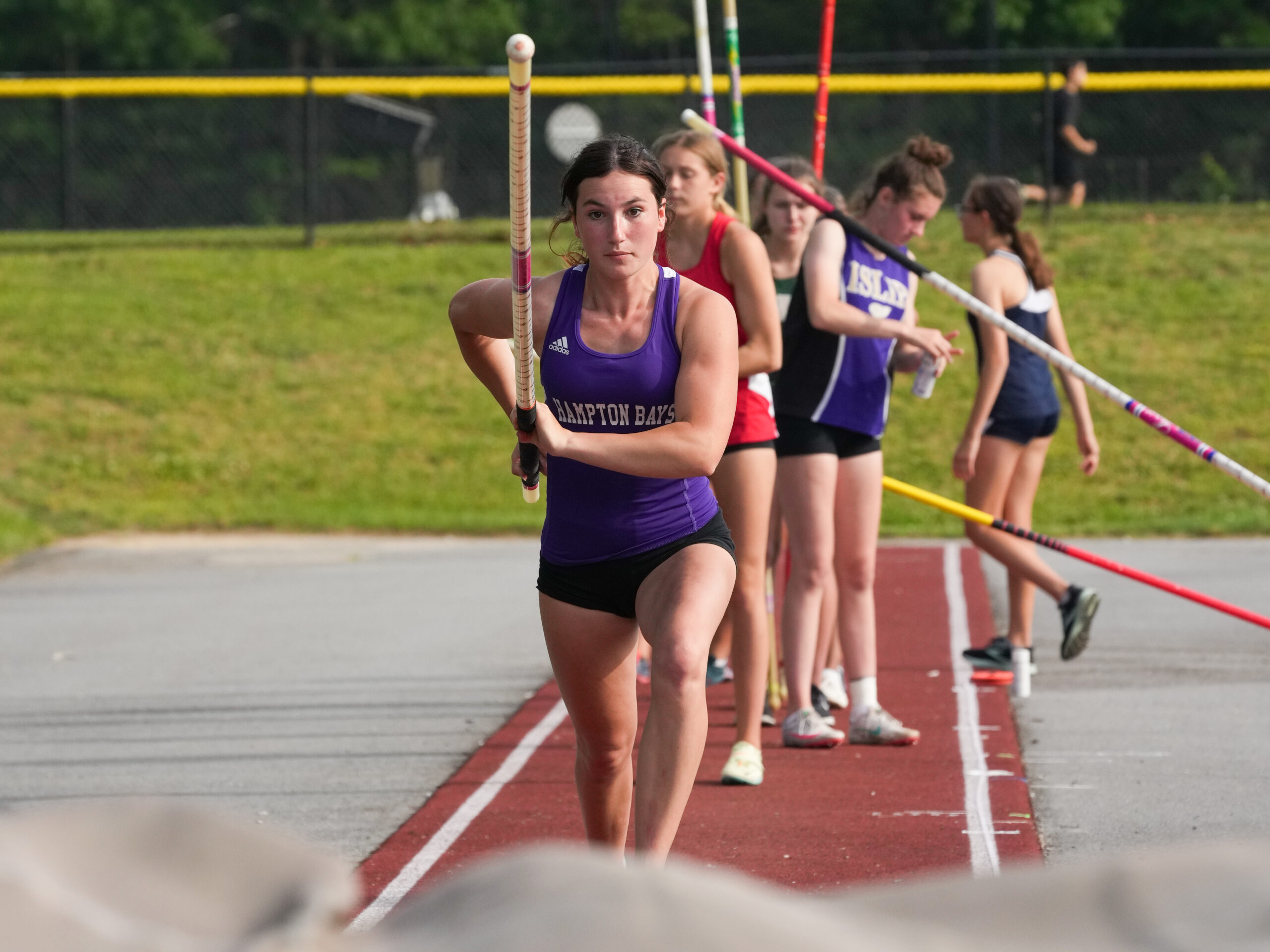 Junior Maizie Poulakis competes in the pole vault during the state qualifiers. RON ESPOSITO