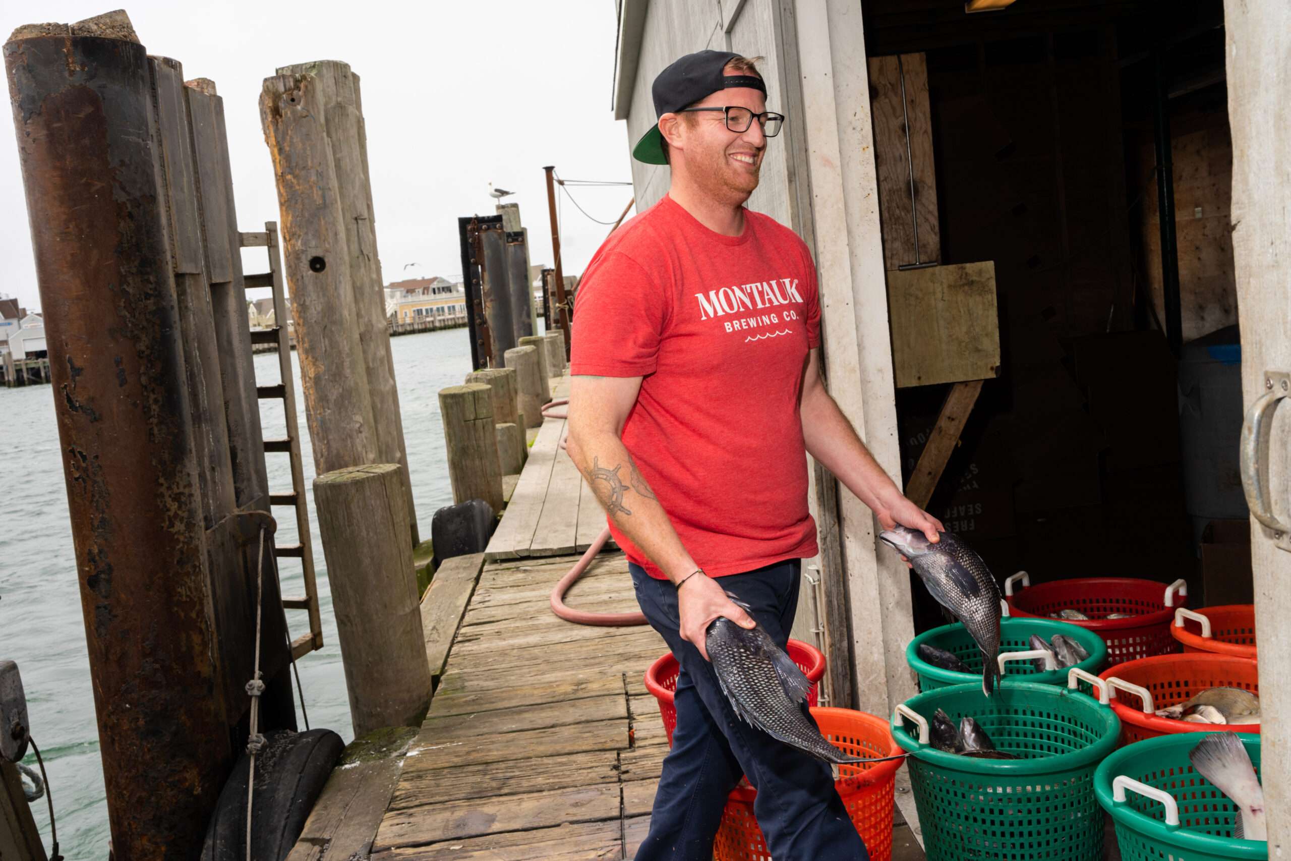 Wesley Peterson, co-owner of Montauk Seafood Company, buying locally caught fish right off the Amanda Joy just after its return to dock. 