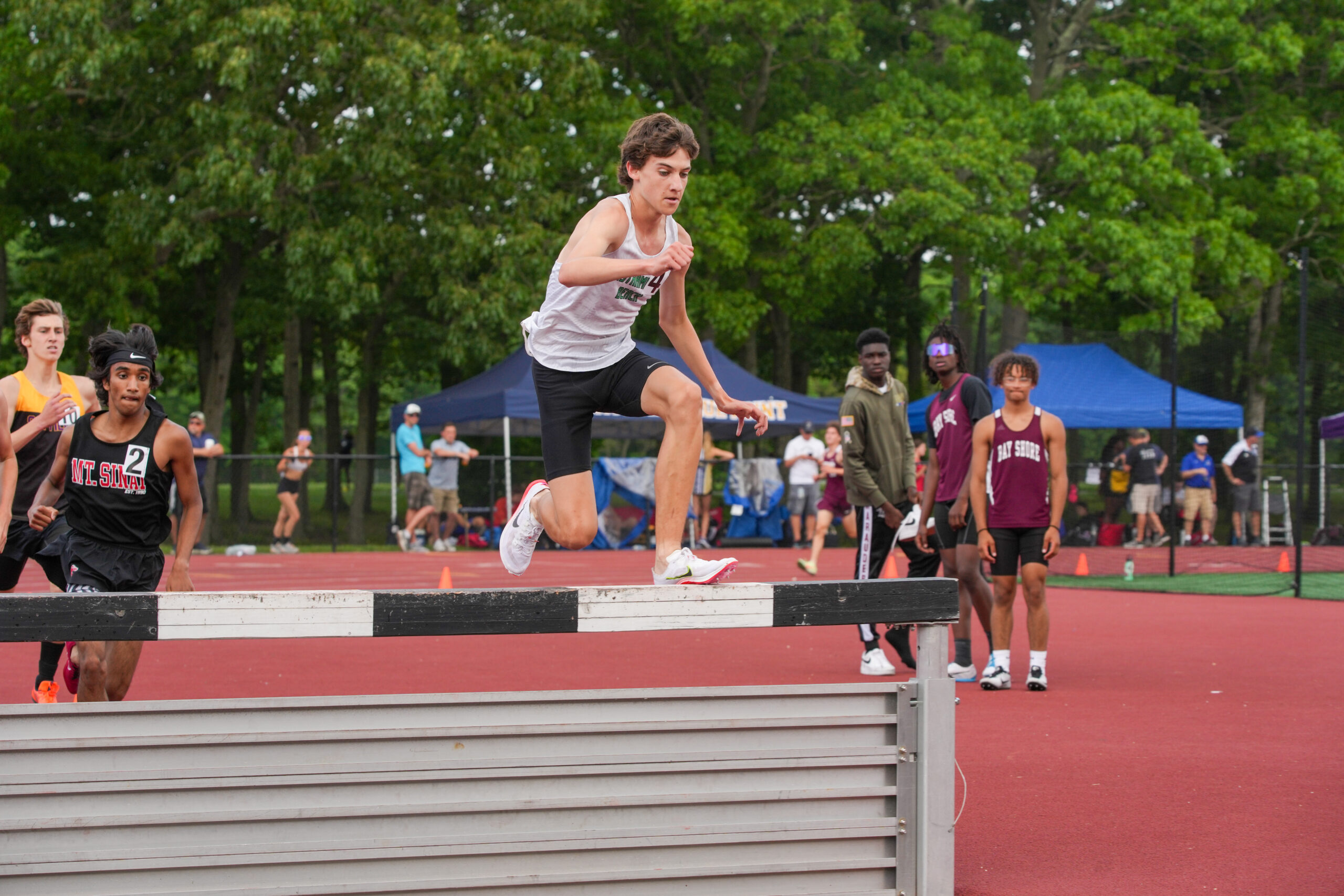 Sophomore Trevor Hayes jumps a hurdle in the 3,000-meter steeplechase at the state qualifiers. RON ESPOSITO