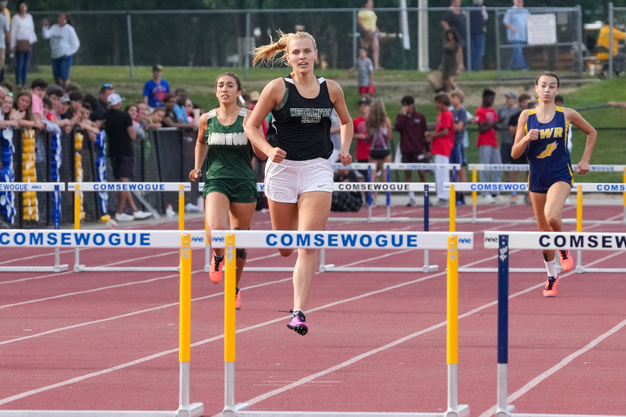 Senior Valerie Finke races in the 400-meter hurdles at the state qualifiers. RON ESPOSITO