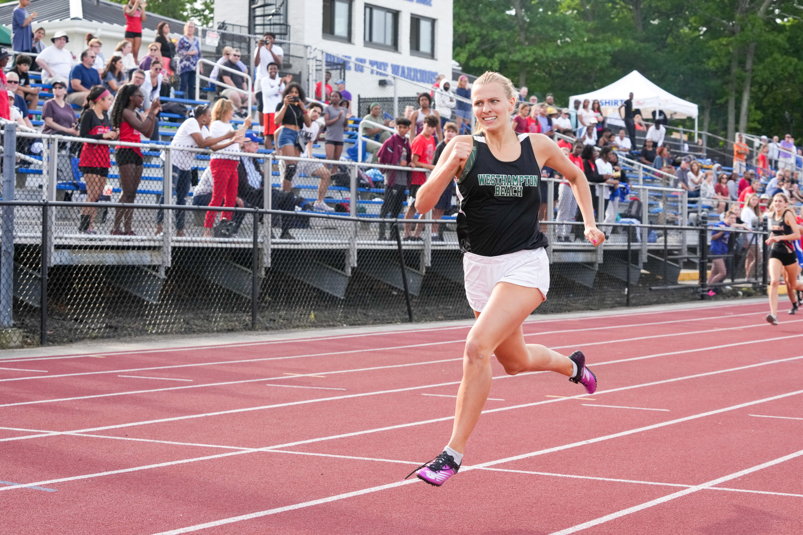 Senior Valerie Finke races in the 400-meter hurdles at the state qualifiers. RON ESPOSITO
