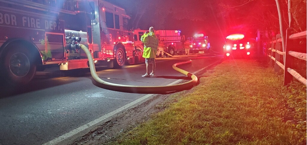 Fire hose snakes across the road.   CHRISTINE HOYT