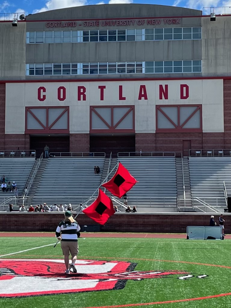 Kathy Masterson, in her last year at Westhampton Beach before moving to East Hampton in the fall, waving the Hurricanes flag on the field at Cortland University, after the Westhampton Beach girls lacrosse team advanced to the state final four there this year.