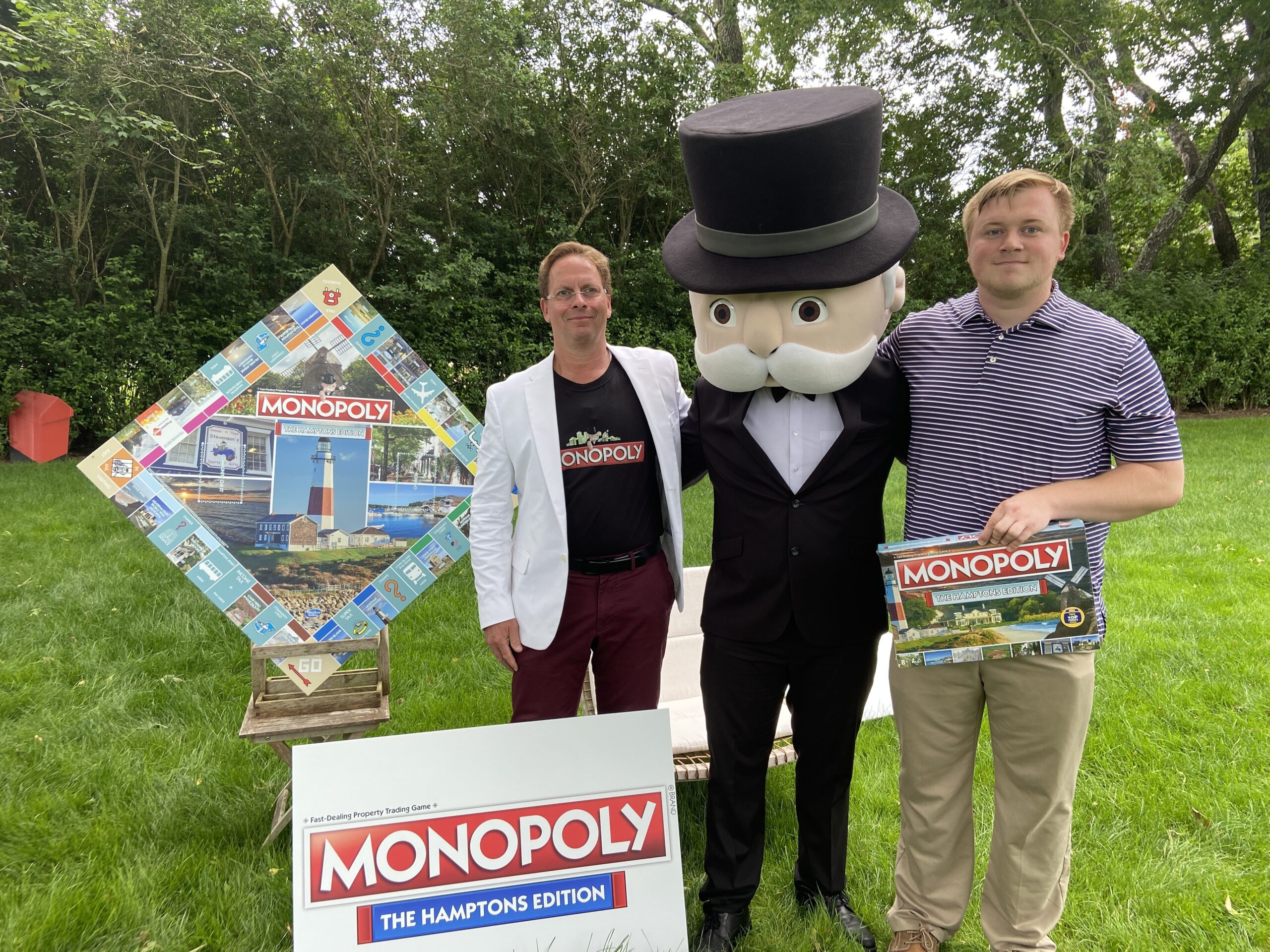 BY JULIA HEMING Scott Whiney, Mr. Monopoly and Dennis Gavaghen celebrate the reveal of Monopoly Hamptons Edition.