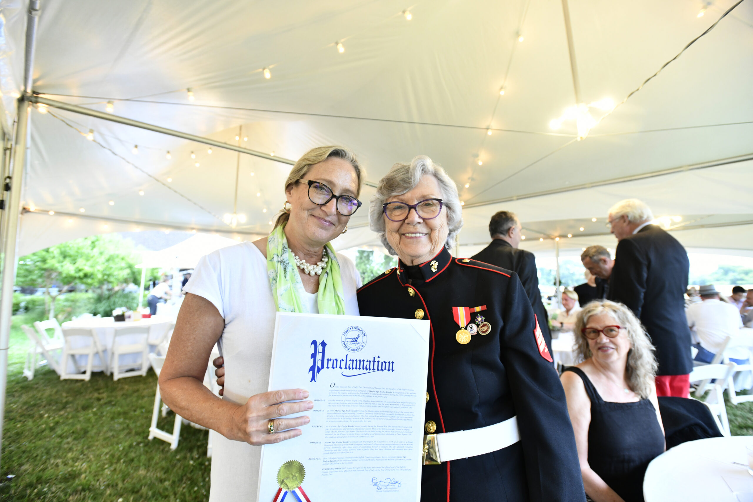 Suffolk County Legislator Bridget Fleming presents a proclamation to Marine Sgt. Evelyn Kandel at the Honor Flight Long Island Listen To The Wind gala on Saturday evening at the Sagaponack Farm Distillery.  DANA SHAW