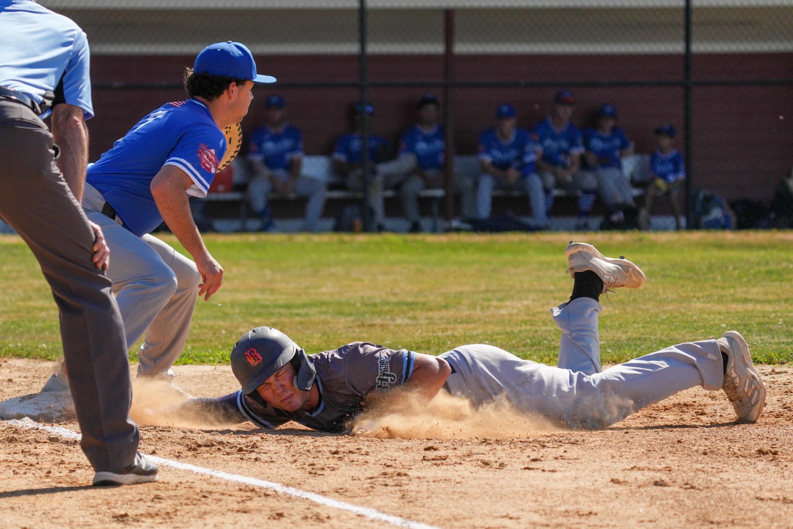 A Sag Harbor Whaler dives back to first base during a pickoff attempt.    RON ESPOSITO