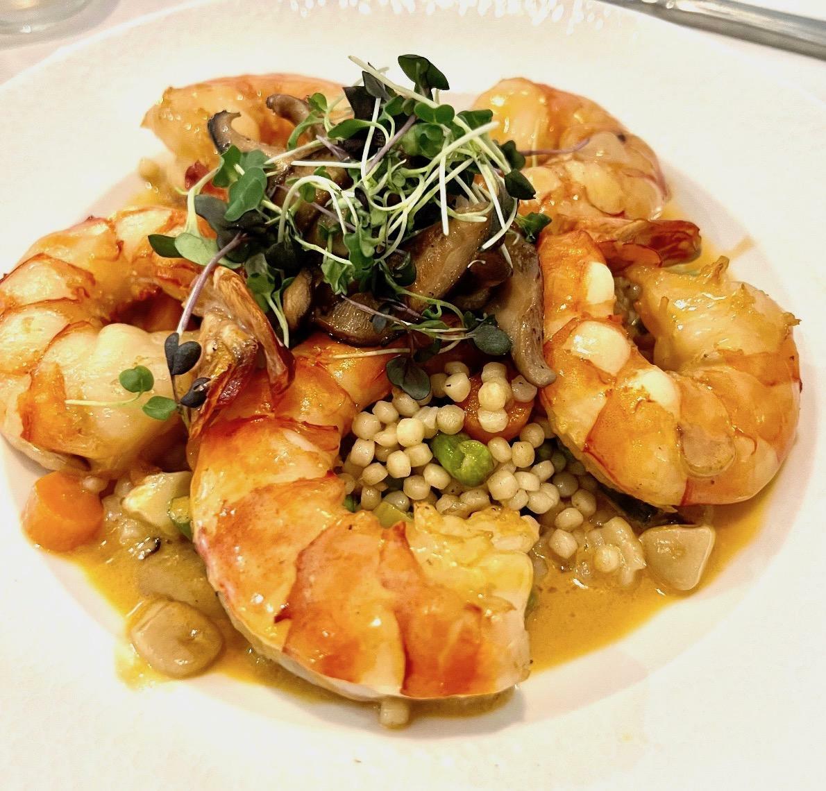 Chef Giancarlo's Jumbo shrimp in aged cognac with pearl vegetable couscous, fried leeks, creamy shrimp sauce is on the menu at Claude's. COURTESY SOUTHAMPTON INN