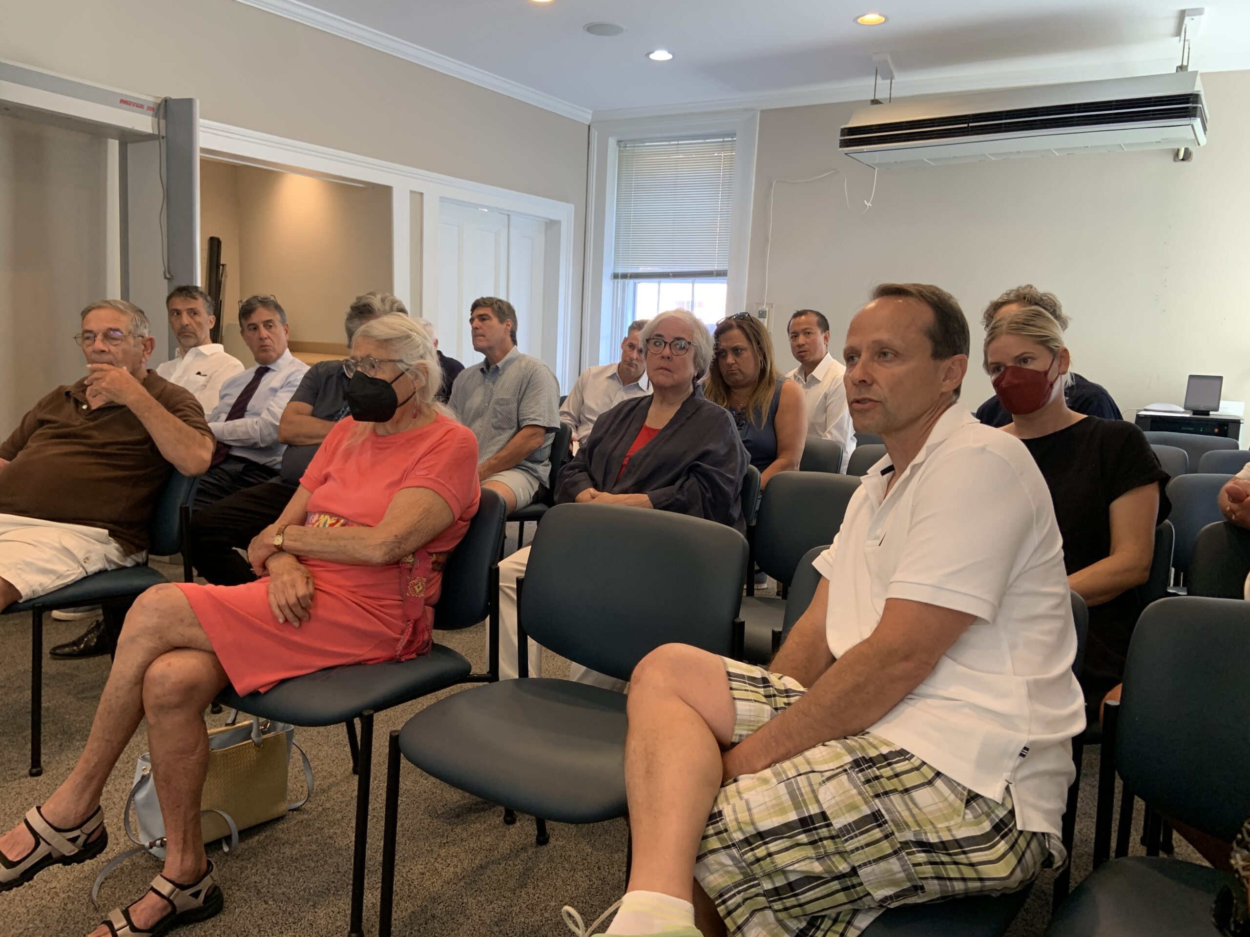 Adam Potter listens as the Sag Harbor Village Board took its first look on Friday at a 69-unit affordable housing and commercial development he has proposed for property he has acquired off Bridge and Rose streets. STEPHEN J. KOTZ