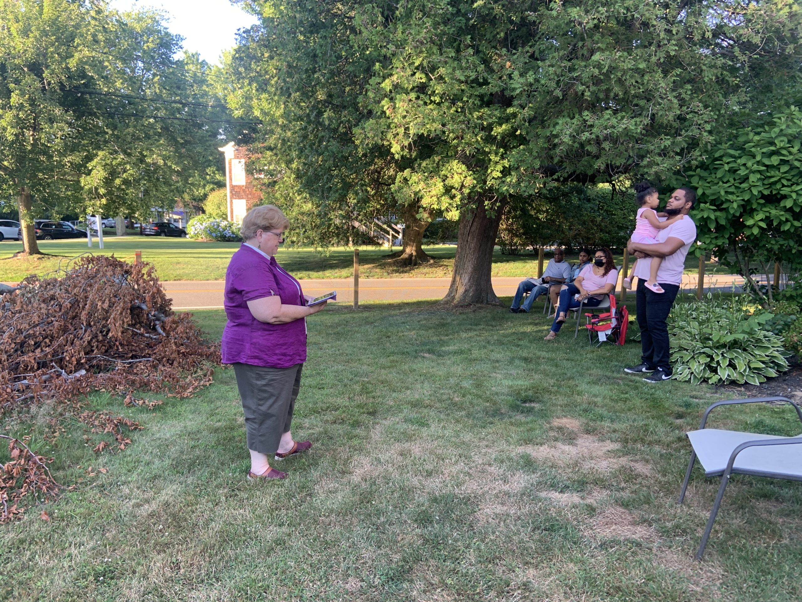 The Reverend Joanne Utley leads a prayer service at the foot of a damaged and diseased European weeping beech next to the former Bridgehampton United Methodist Church, which will be removed in the coming days. STEPHEN J. KOTZ