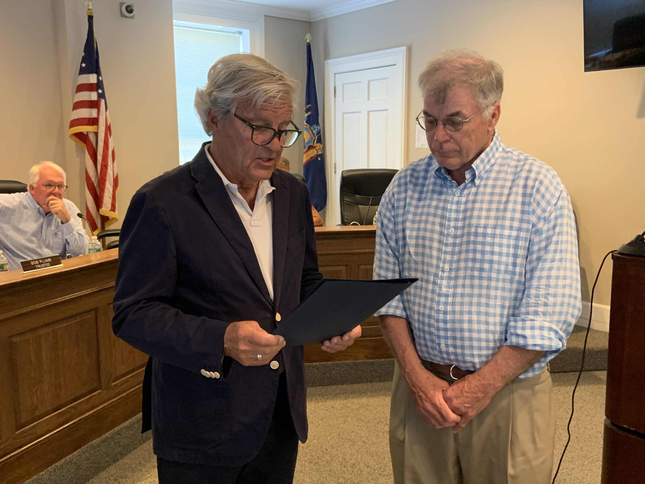 Mayor Jim Larocca, left, presents Dennis Winter with a proclamation honoring him for rescuing a woman from a burning boat on May 29. STEPHEN J. KOTZ