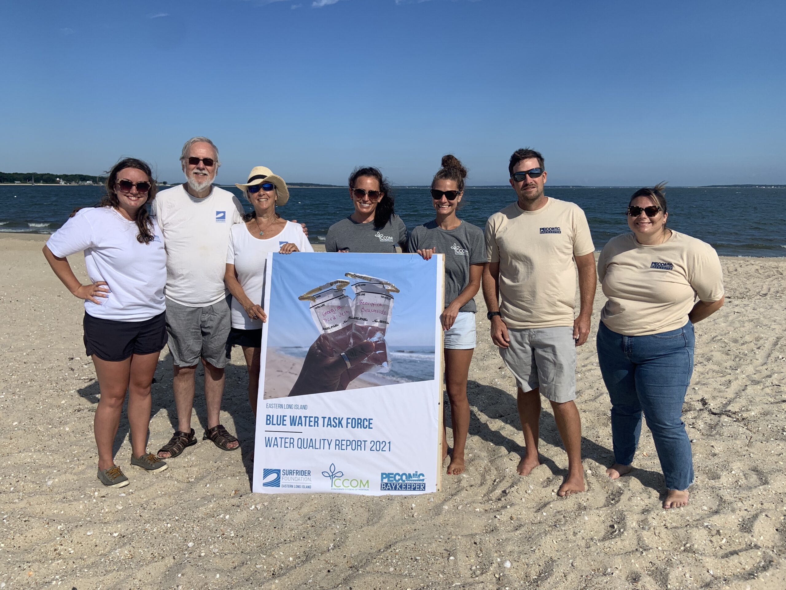Jenna Schwerzmann of Surfrider, volunteers Tom and Heidi Oleszczuk, Jaime LeDuc and Laura Tooman of Concerned Citizens of Montauk, and Peter Topping and Alexa Annunziata of the Peconic Baykeeper, gather at Long Beach in Noyac Tuesday morning to announce the release of their water quality report for 2021.  STEPHEN J. KOTZ