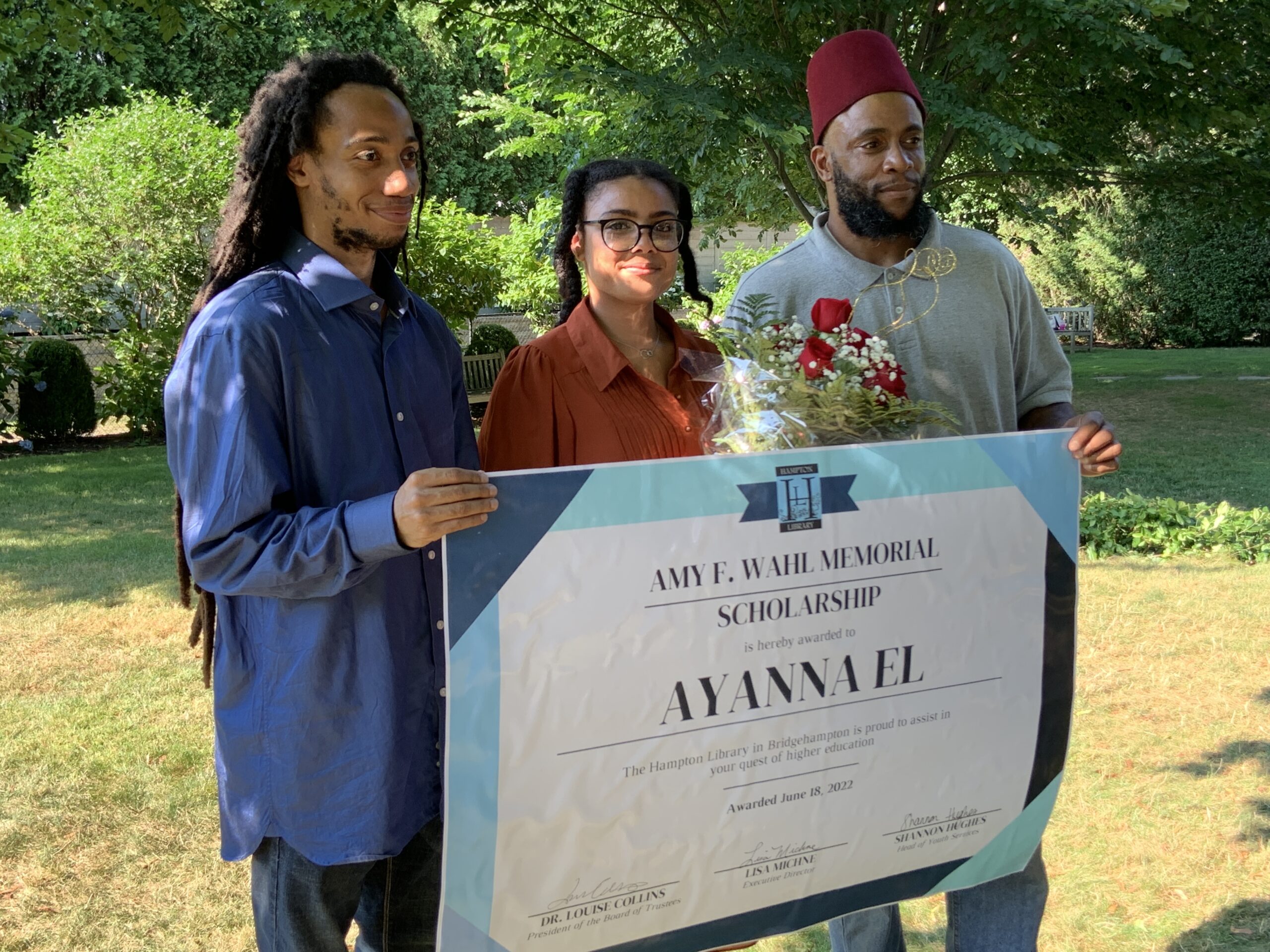 Ayanna El, the winner of the Amy F. Wahl Memorial Scholarship, is flanked by her brother Ameer El, left, and father, Muslim El, right, at a reception at the Hampton Library on July 20. STEPHEN J. KOTZ