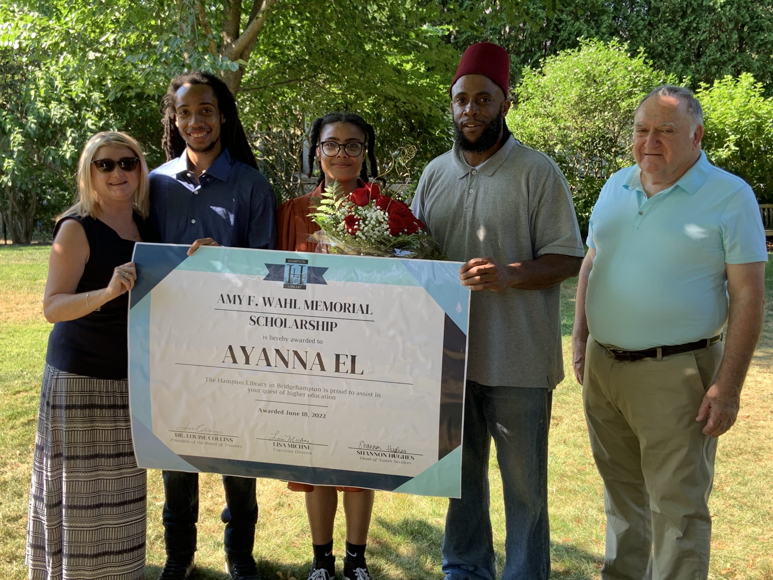 Ayanna El, the winner of the Amy F. Wahl Memorial Scholarship, is flanked by her brother Ameer El, left, and father, Muslim El, as well as Wahl's sister, Heather DeSanto, far left, and Wahl's father, Bill Wahl, right, at a reception at the Hampton Library on July 20. STEPHEN J. KOTZ