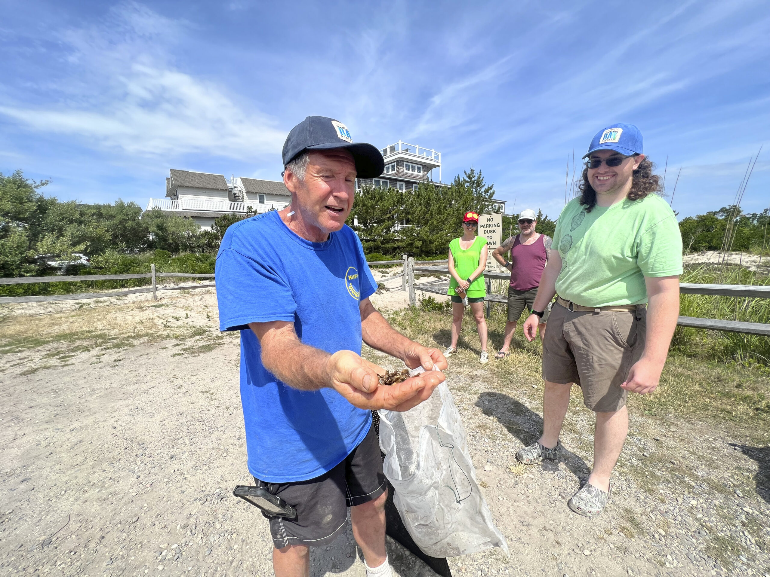 Kim Tetrault of Cornell Cooperative Extension with oyster seedlings at the Moriches Bay Project's learn how to make an oyster cage and set up a farm event in Westhampton on July 8.  DANA SHAW