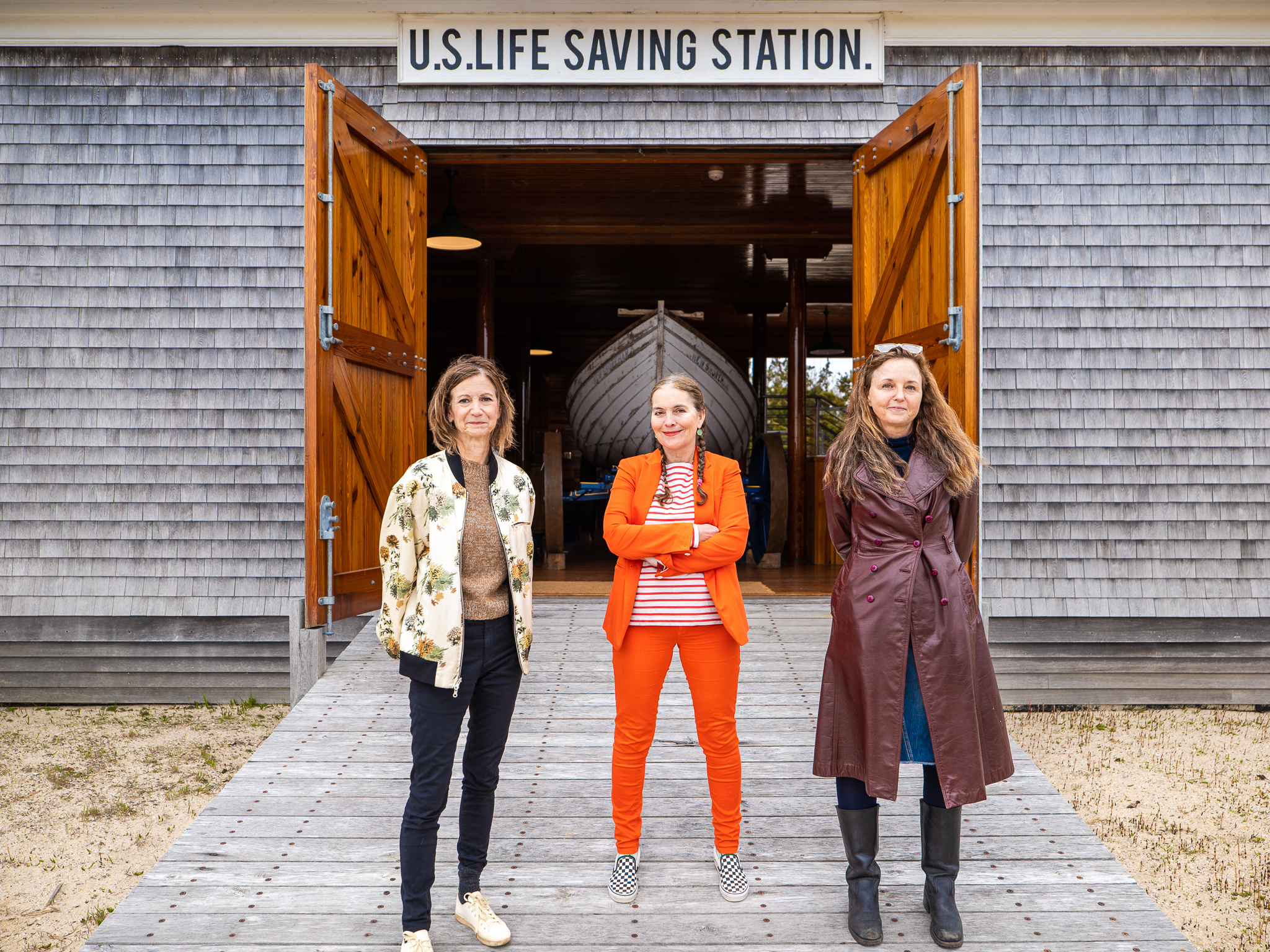 No W here Collective, Toni Ross, Bastenne Schmidt, and Alice Hope, standing in front of the Amagansett U.S. Life Saving Station, 2022. 