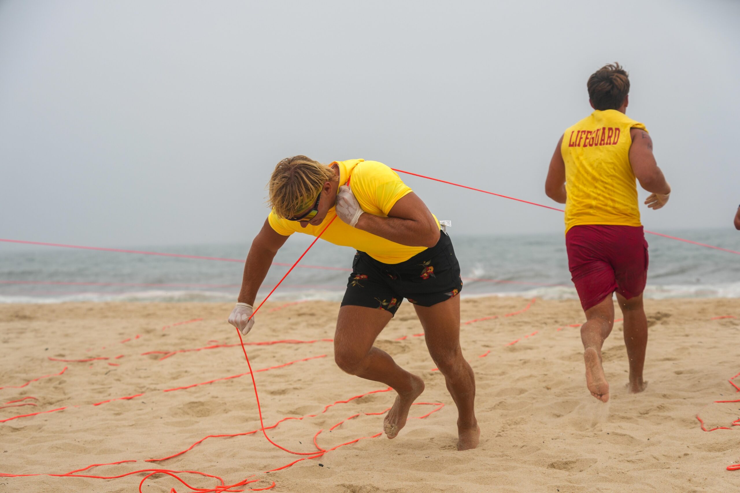Lifeguards compete in the land line rescue at the East Hampton Main Beach Competition on July 21.    RON ESPOSITO