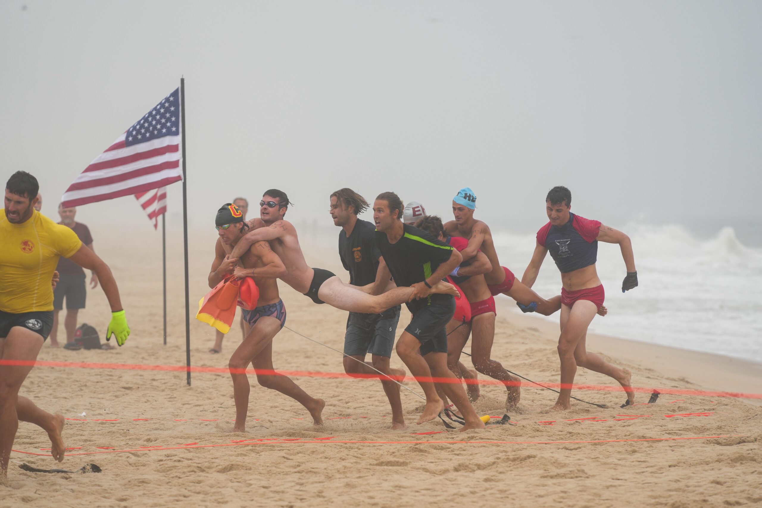 Lifeguards compete in the land line rescue at the East Hampton Main Beach Competition on July 21.    RON ESPOSITO