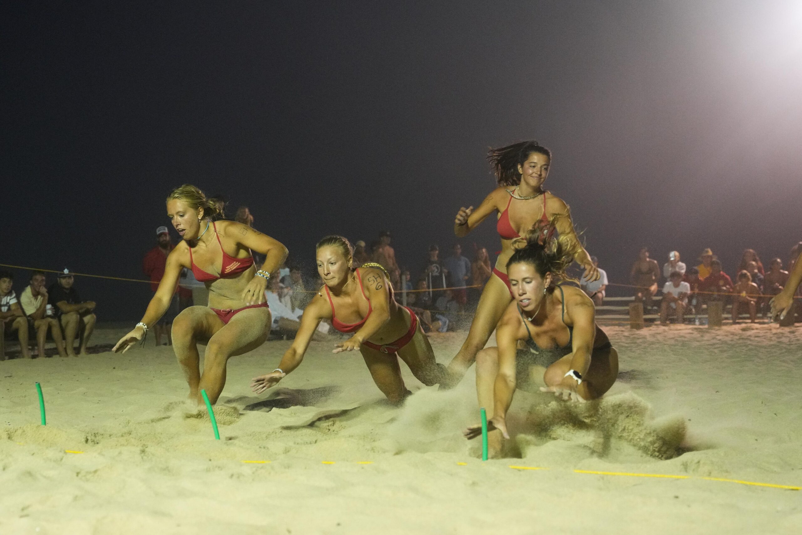 The women compete in their beach flags event.    RON ESPOSITO