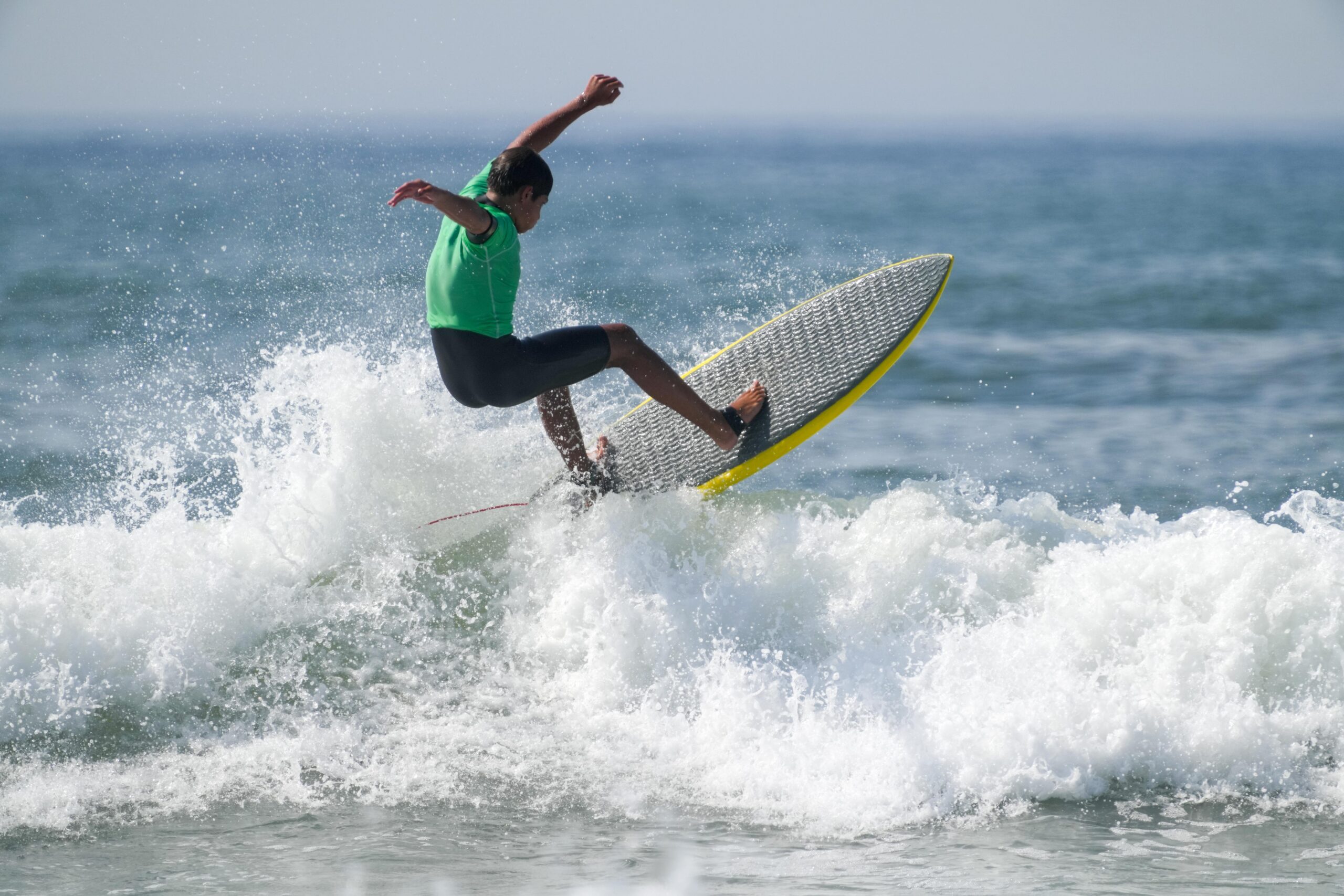Surfers compete in the 24th annual Rell Sunn Memorial Surf Contest at Ditch Plains on Saturday morning.    RON ESPOSITO