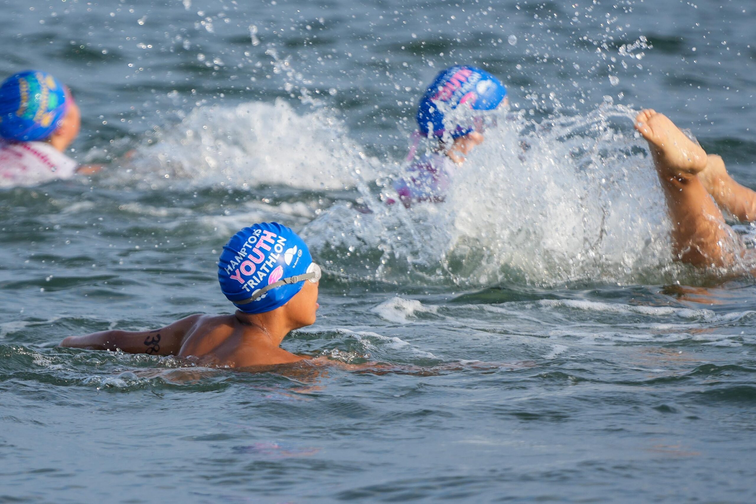 Athletes compete in the swim portion of the Hamptons Youth Triathlon at Long Beach on Saturday morning. RON ESPOSITO