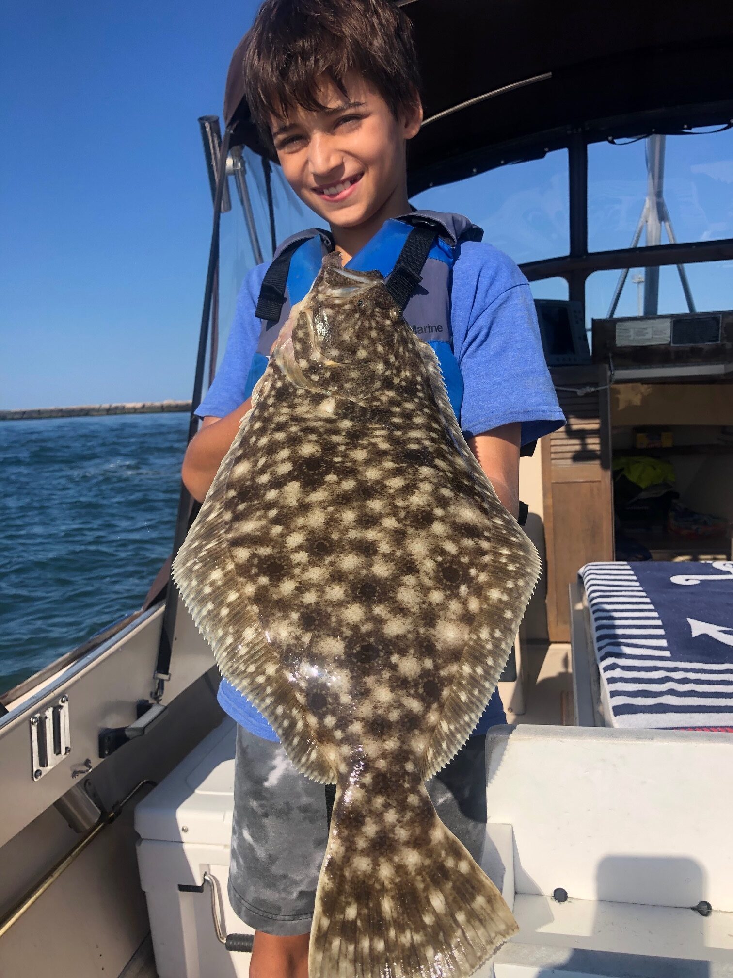 Julian Jain with a beautifully camouflaged fluke caught in Shinnecock Bay last week while fishing with Capt. Brad Ries aboard Someday Came Charters.