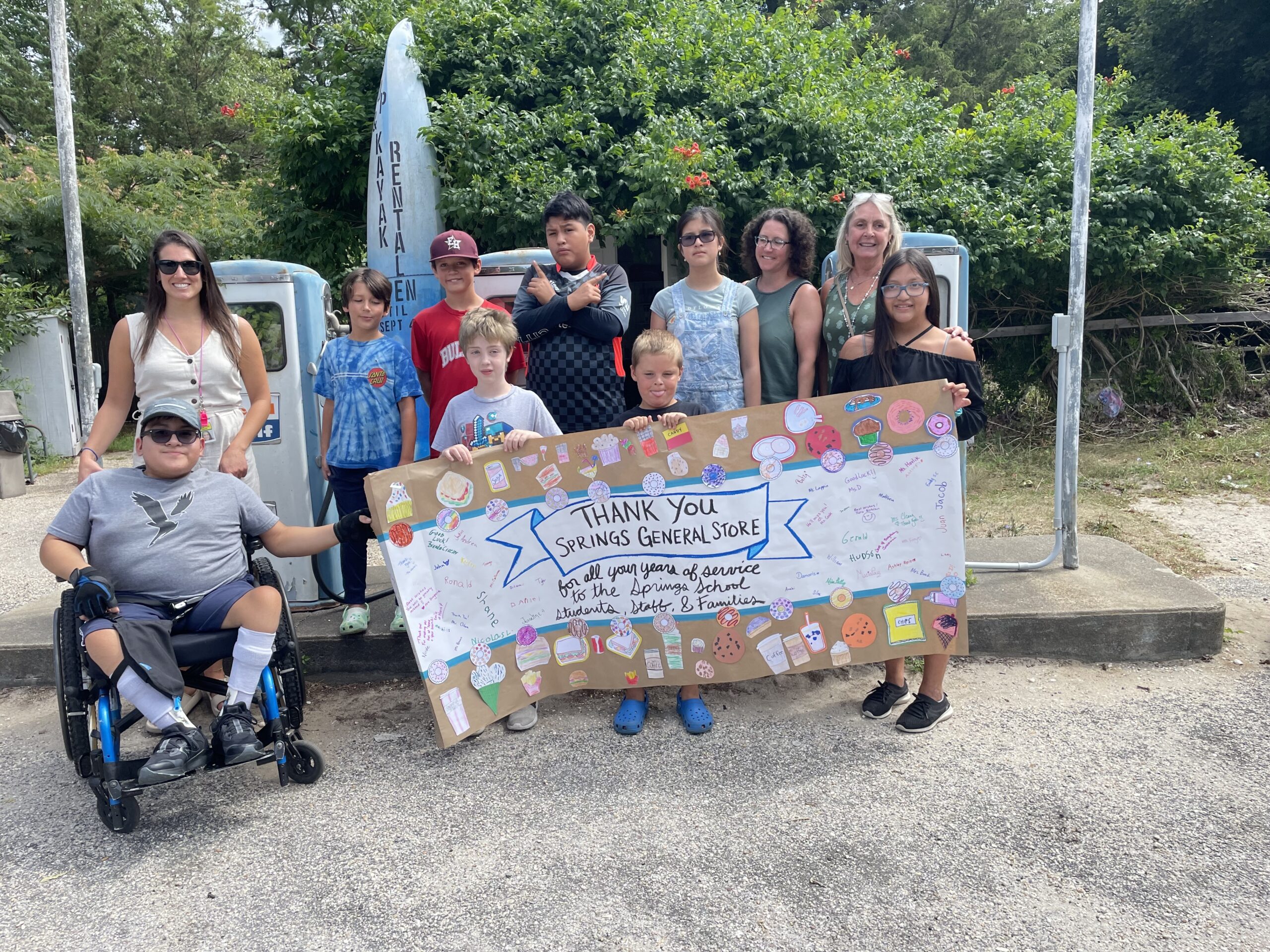 Springs School students delivered a homemade thank you banner to Kristi Hood and her crew at the Springs General Store for years of generosity and service to the Springs community.  The General Store officially closed its doors on August 12. COURTESY CHRISTINE CLEARY